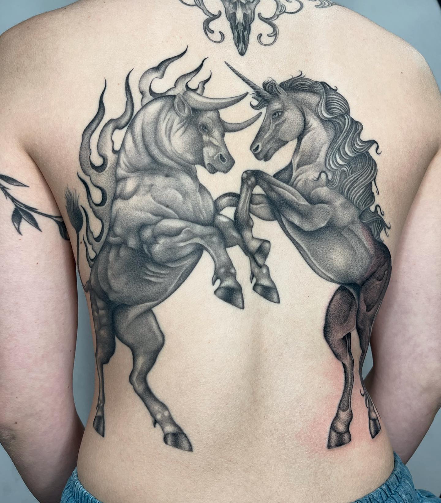 Bull and unicorn realism tattoo on the back by Tiyanna Garlic