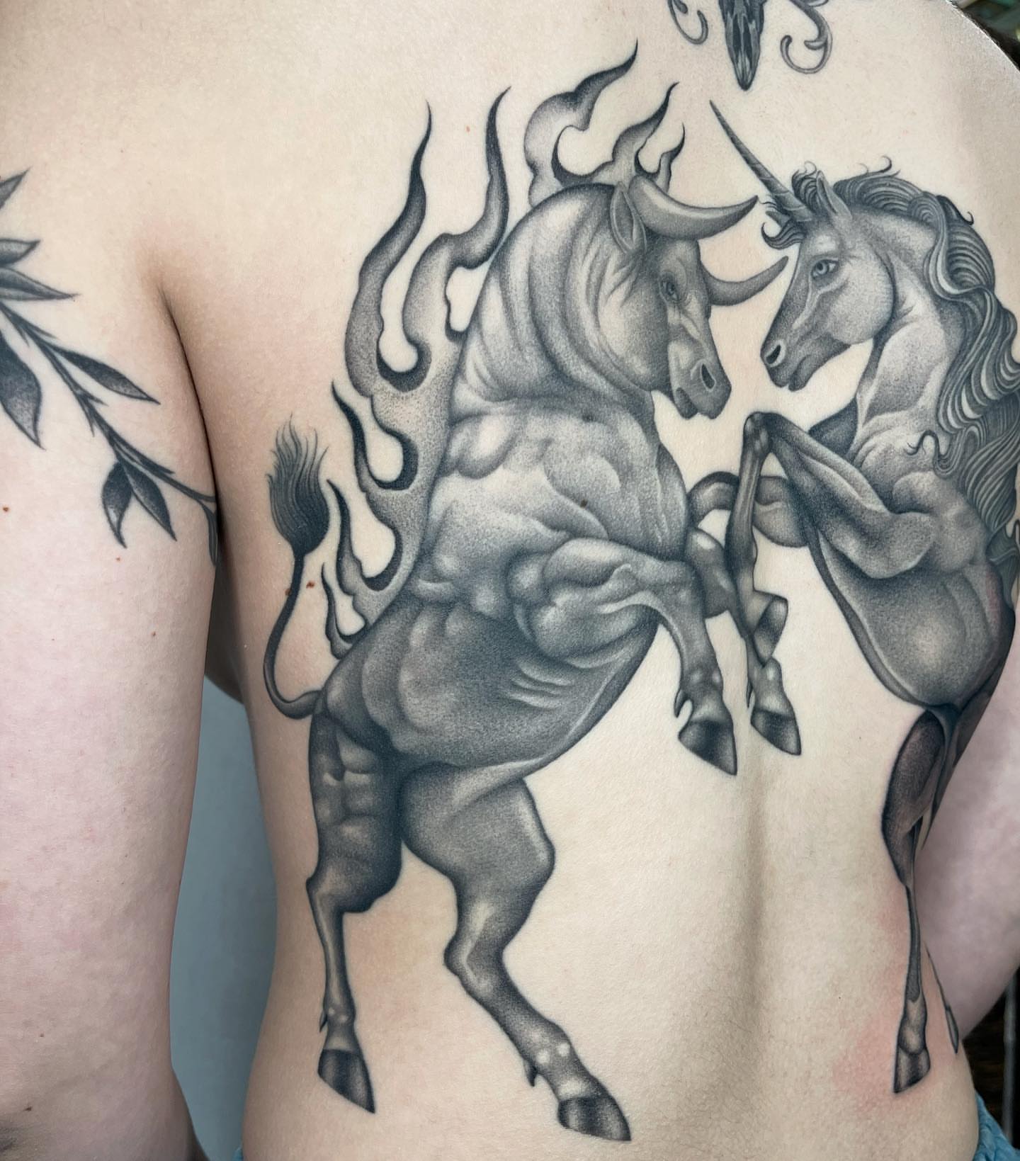 Bull and unicorn realism tattoo on the back by Tiyanna Garlic