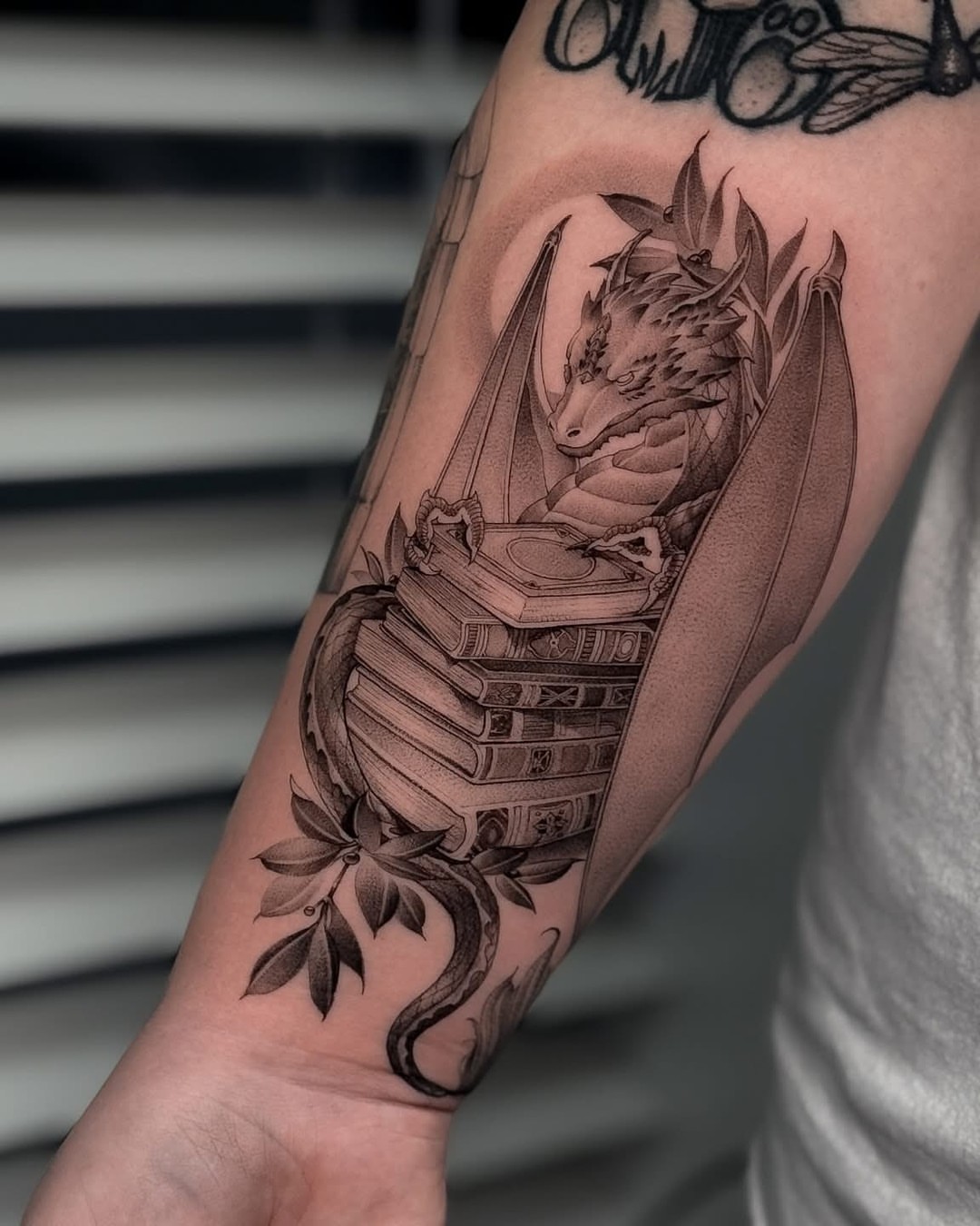 Dragon and books realism tattoo on the forearm by ♡ 𝕍𝕚𝕔𝕥𝕠𝕣𝕚𝕒 ℍ𝕠𝕝𝕞𝕖𝕤 ♡, Avon, Ohio