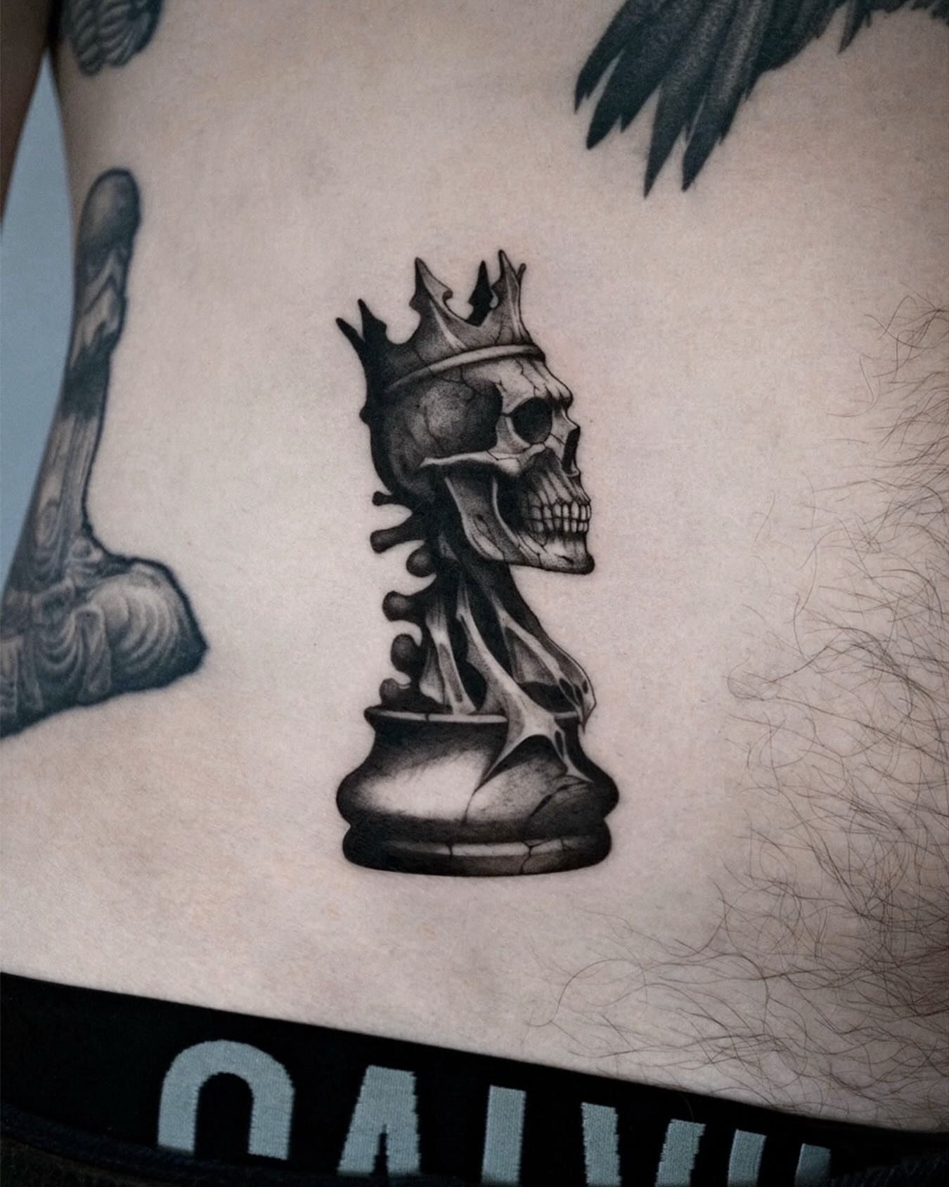 Skull chess piece realism tattoo on the torso by 𝑴𝒆𝒍𝒐