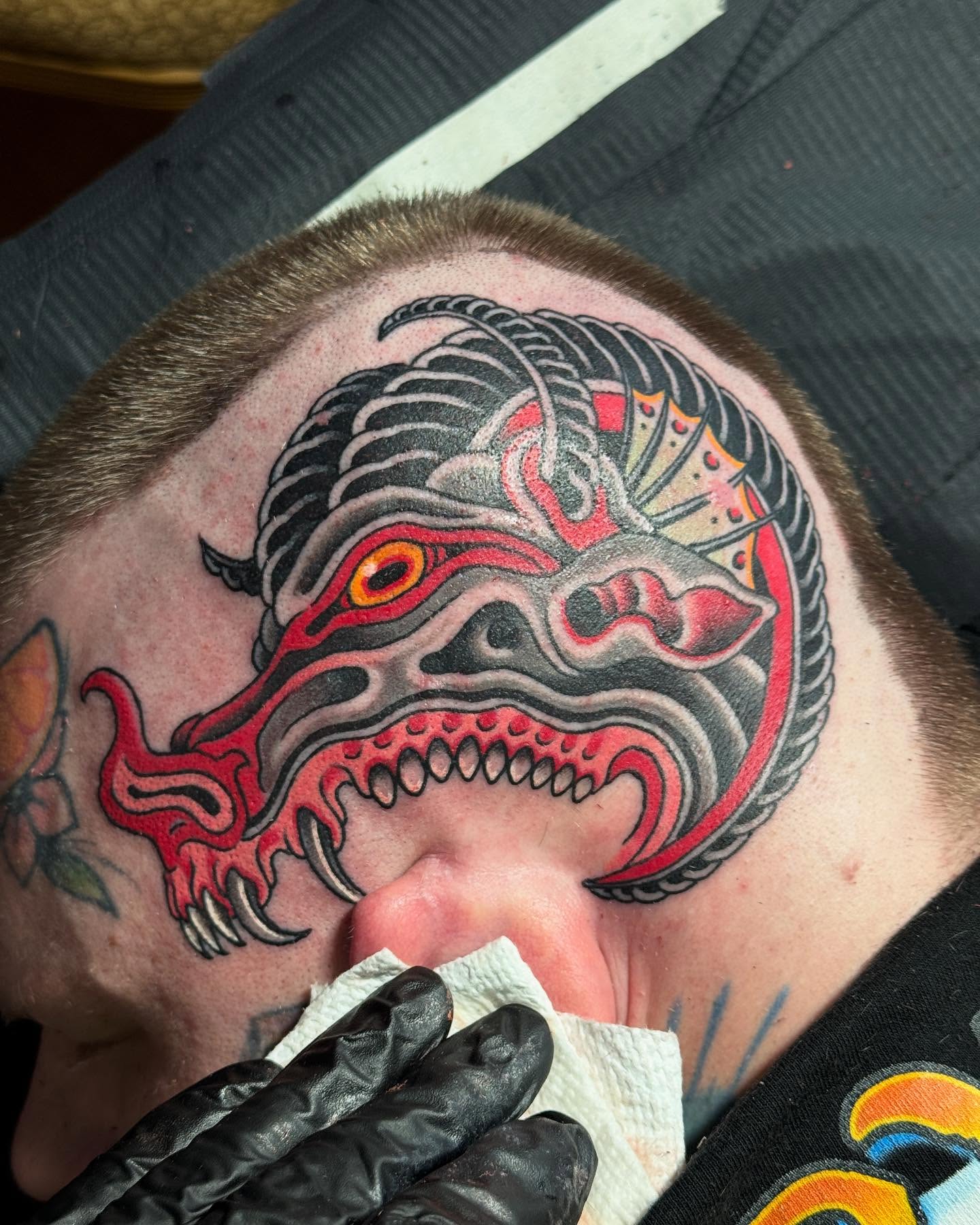 Demon mask American traditional tattoo on the neck by Derek Noble, San Francisco, California