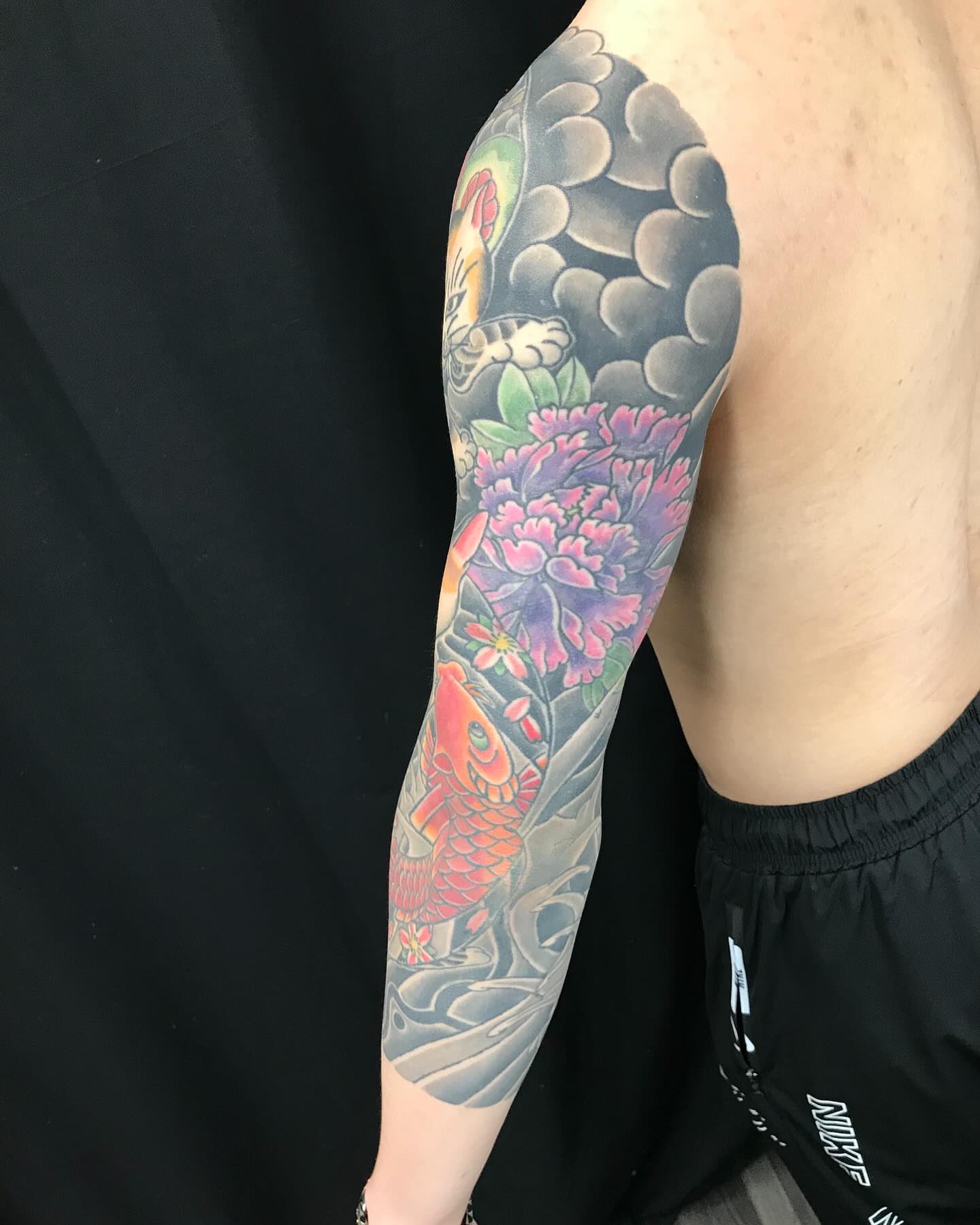 Koi fish and flowers japanese irezumi tattoo on the forearm by Ei Horimiya Omiya