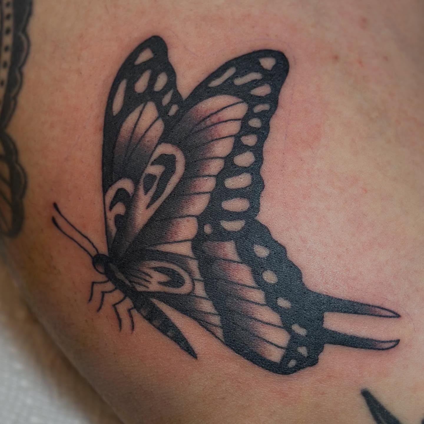 Butterfly black and grey tattoo on the upper arm by @ryleecoyote, New York, New York