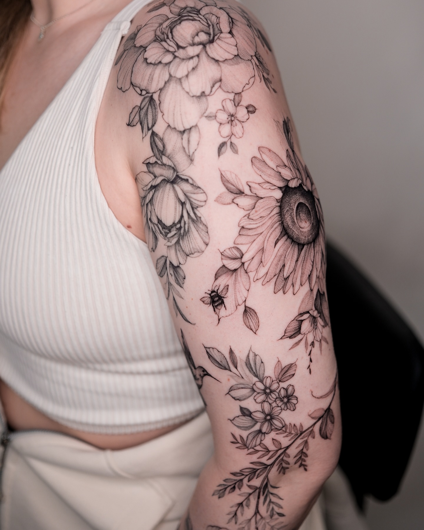 Floral bouquet realism tattoo on the upper arm by Tattoo artist in Boston
