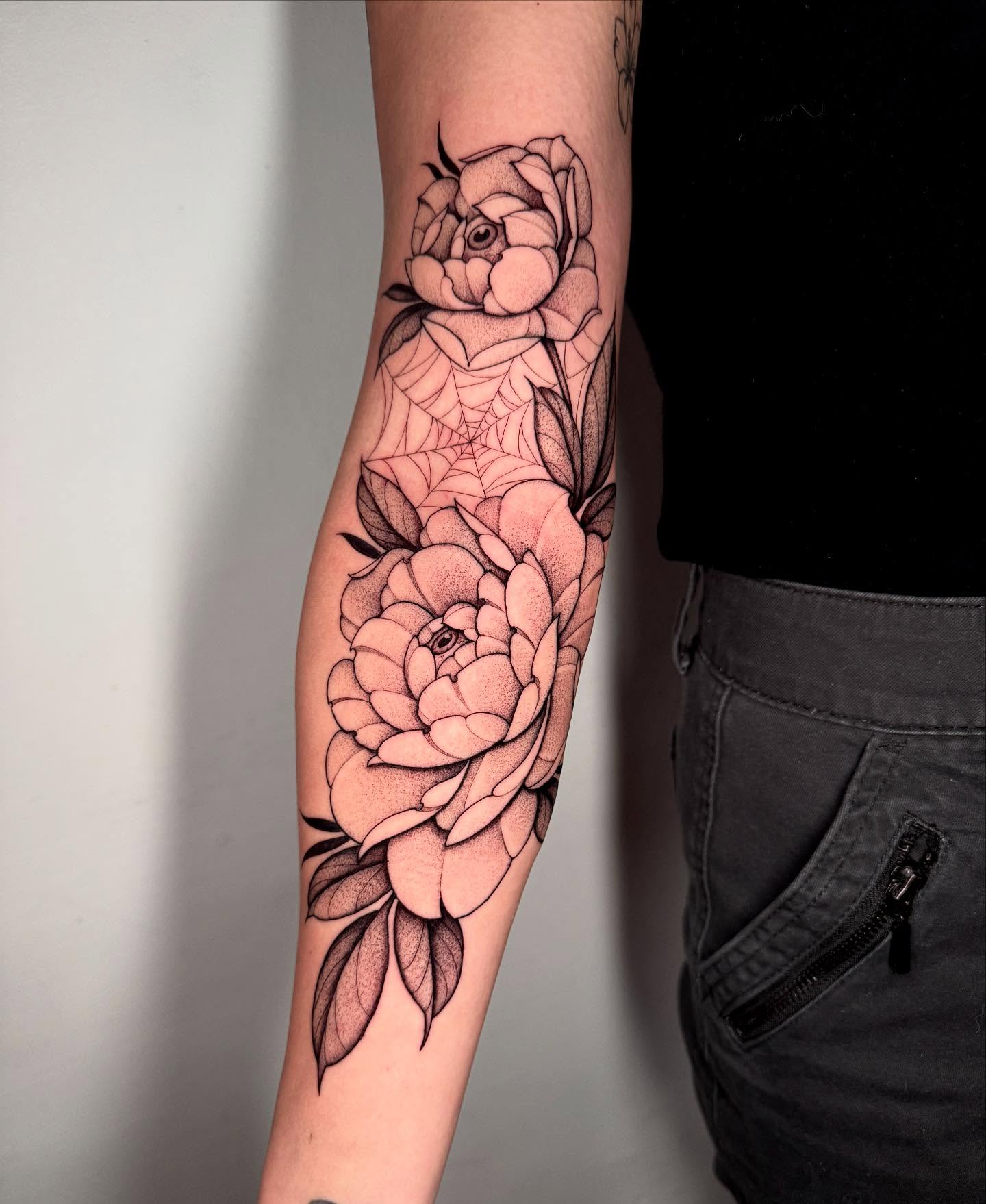 Roses and spiderweb realism tattoo on the forearm by Lauren Llerandi