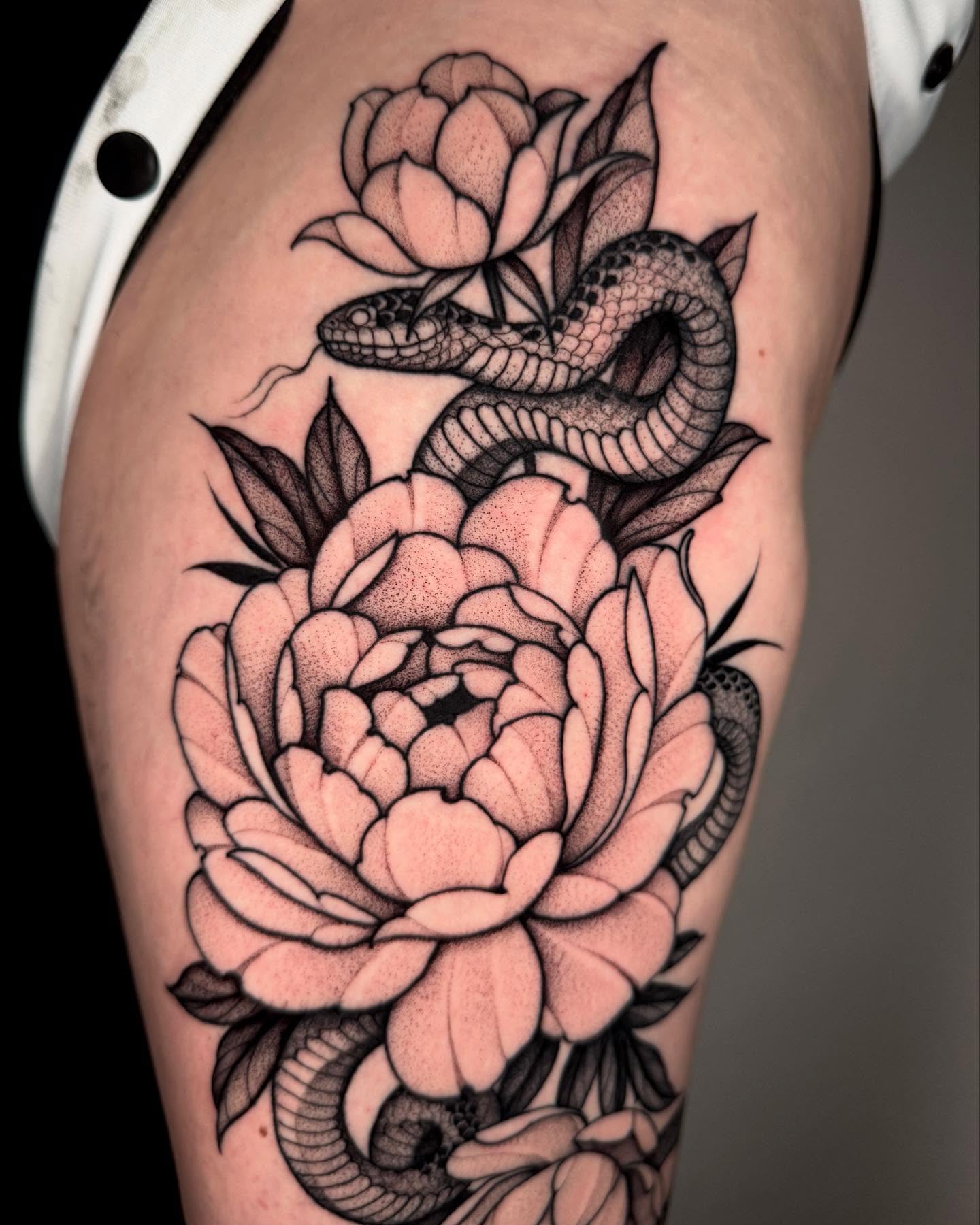 Snake and peony dotwork tattoo on the thigh by Lauren Llerandi