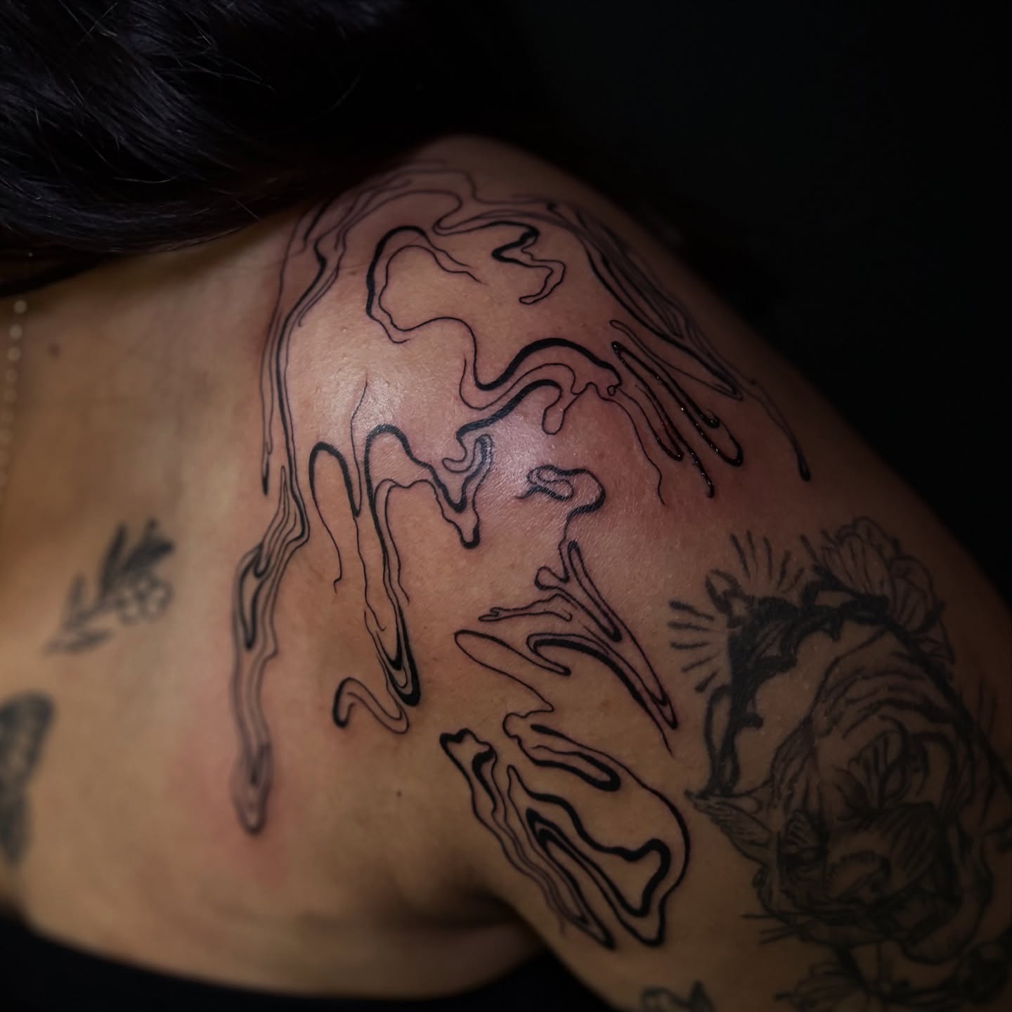 Abstract fluid black and grey tattoo on the shoulder by Tattoos by Marcy