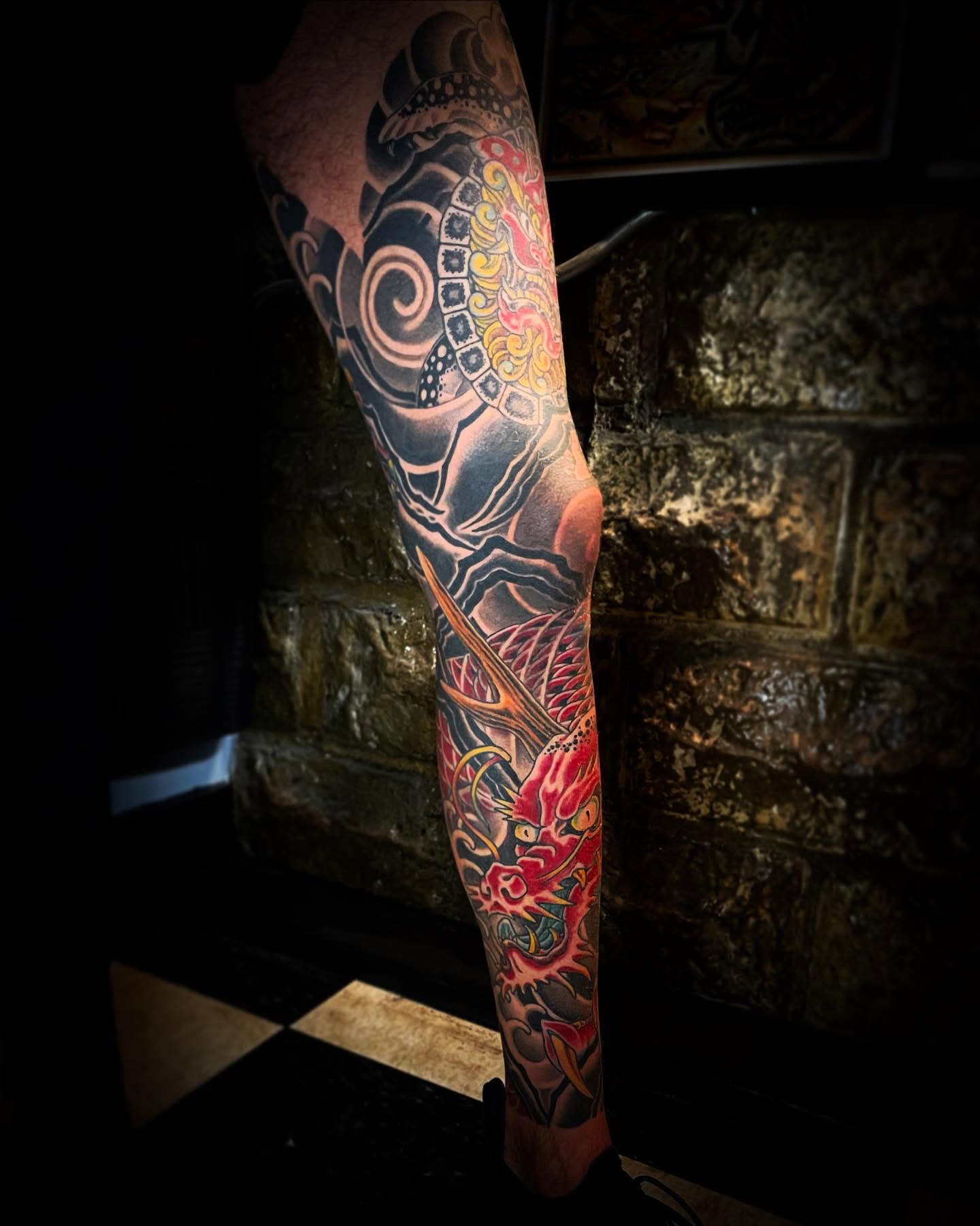 Dragon and mask japanese irezumi tattoo on the forearm by Jacob Finelli