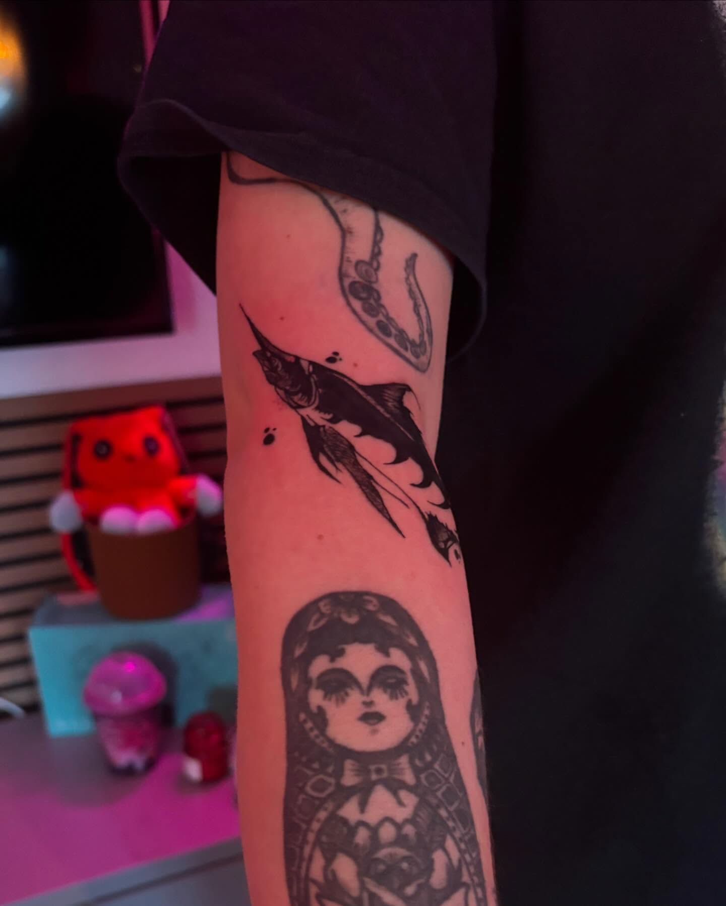 Fish and doll American traditional tattoo on the forearm by lu ๐