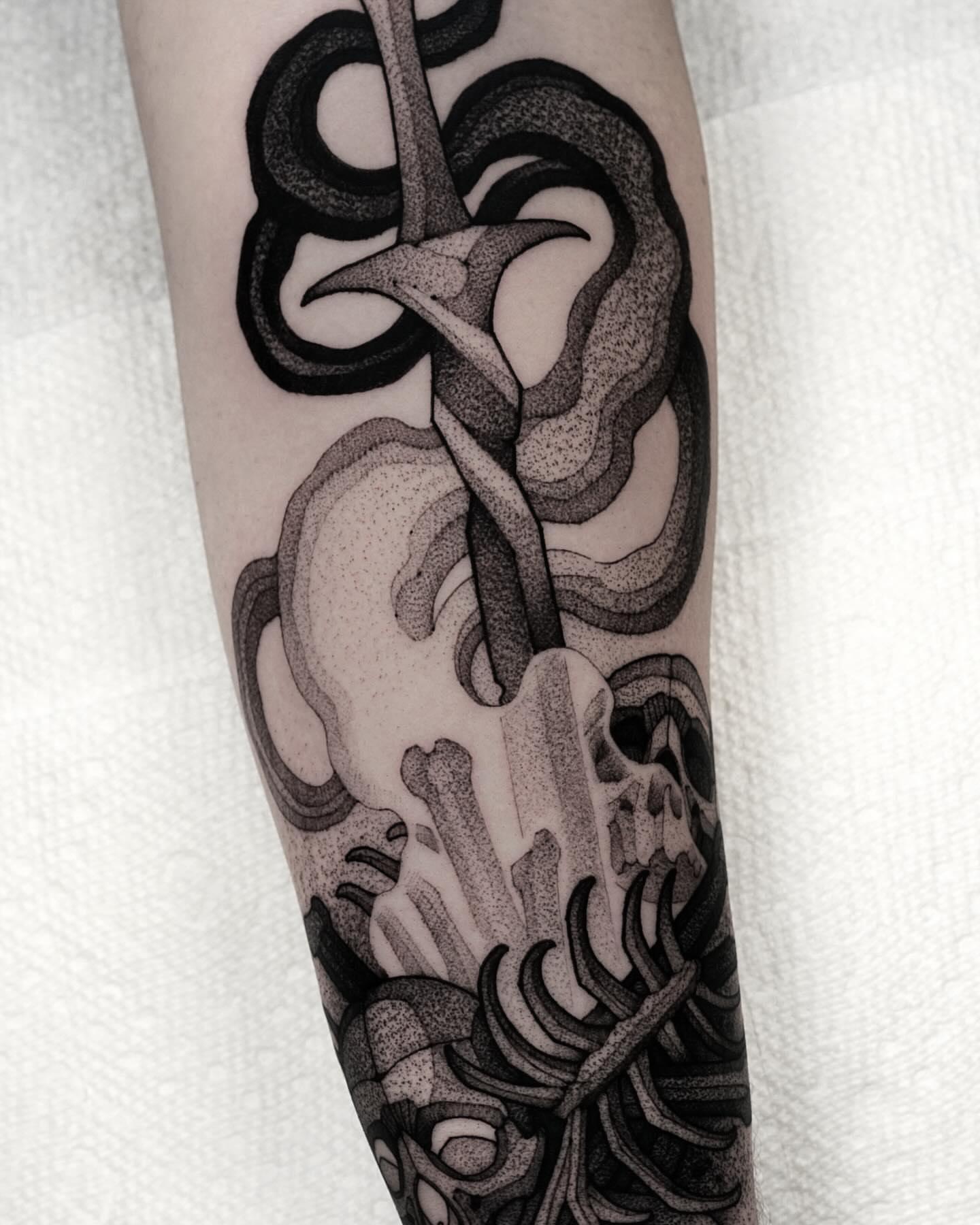 Skull and bones dotwork tattoo on the forearm by Max LaCroix