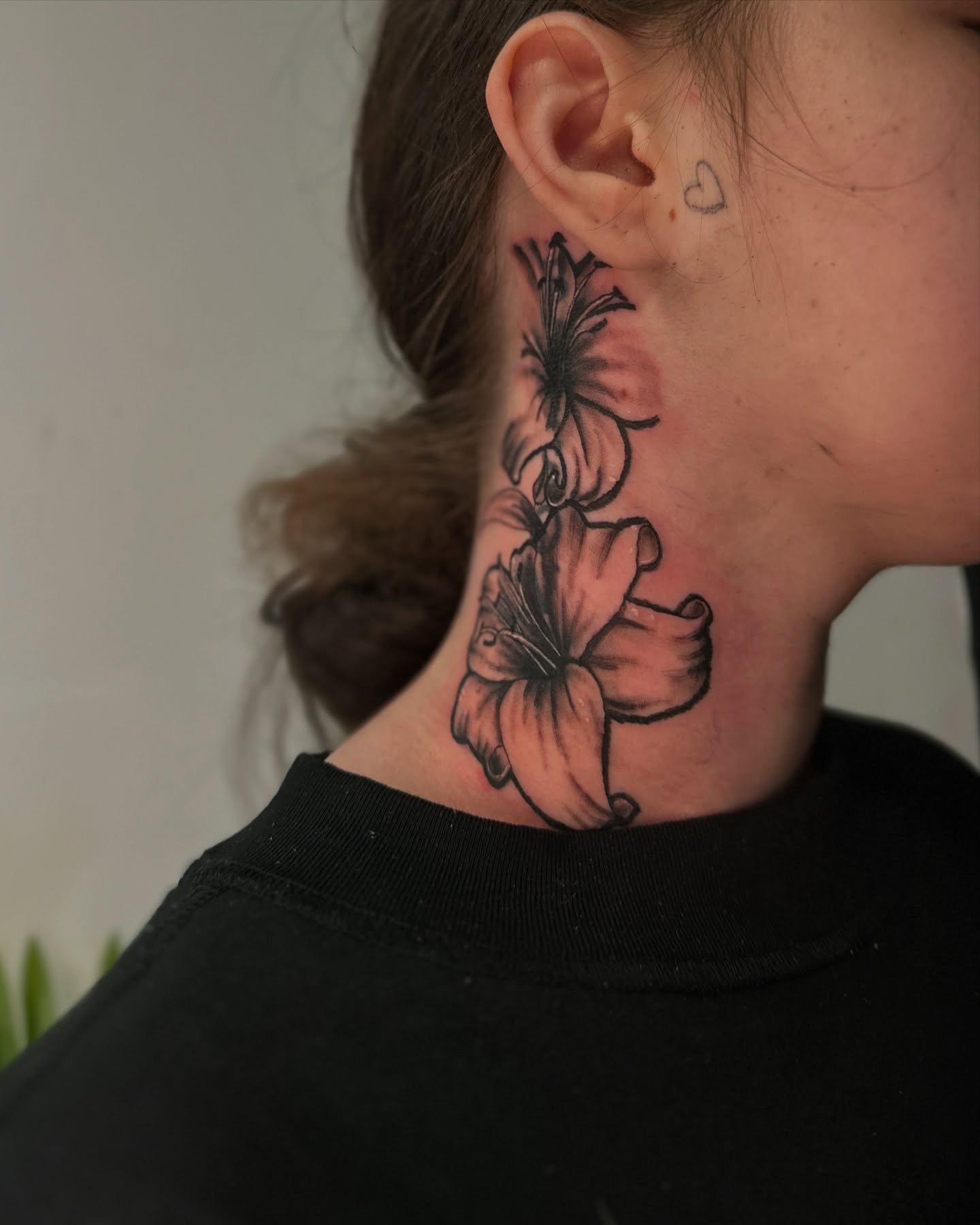 Lily flowers black and grey tattoo on the neck by ᴡᴏʀᴍ
