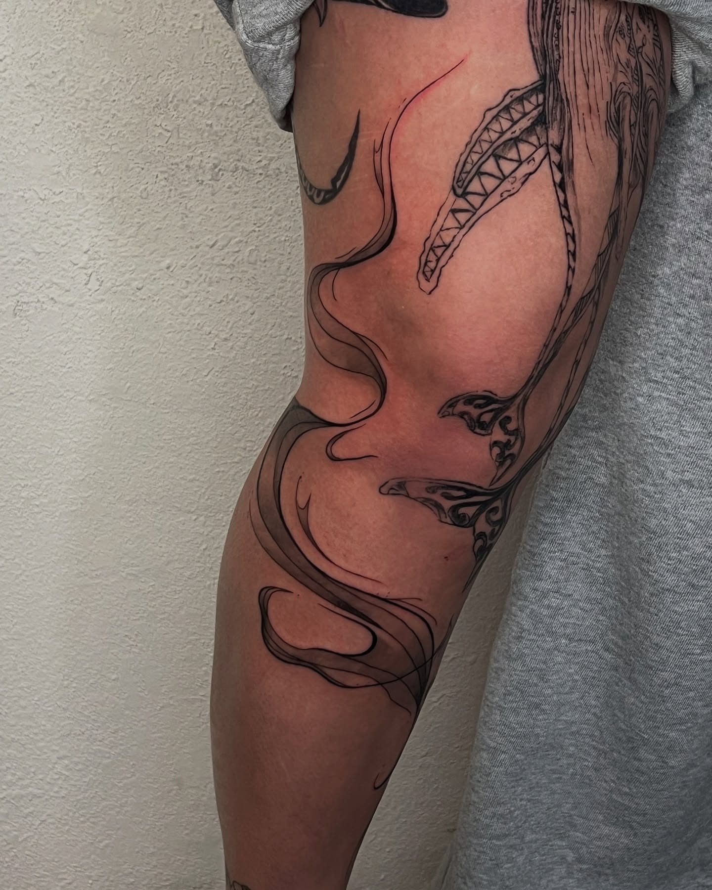 Whale and waves black and grey tattoo on the forearm by Jordan