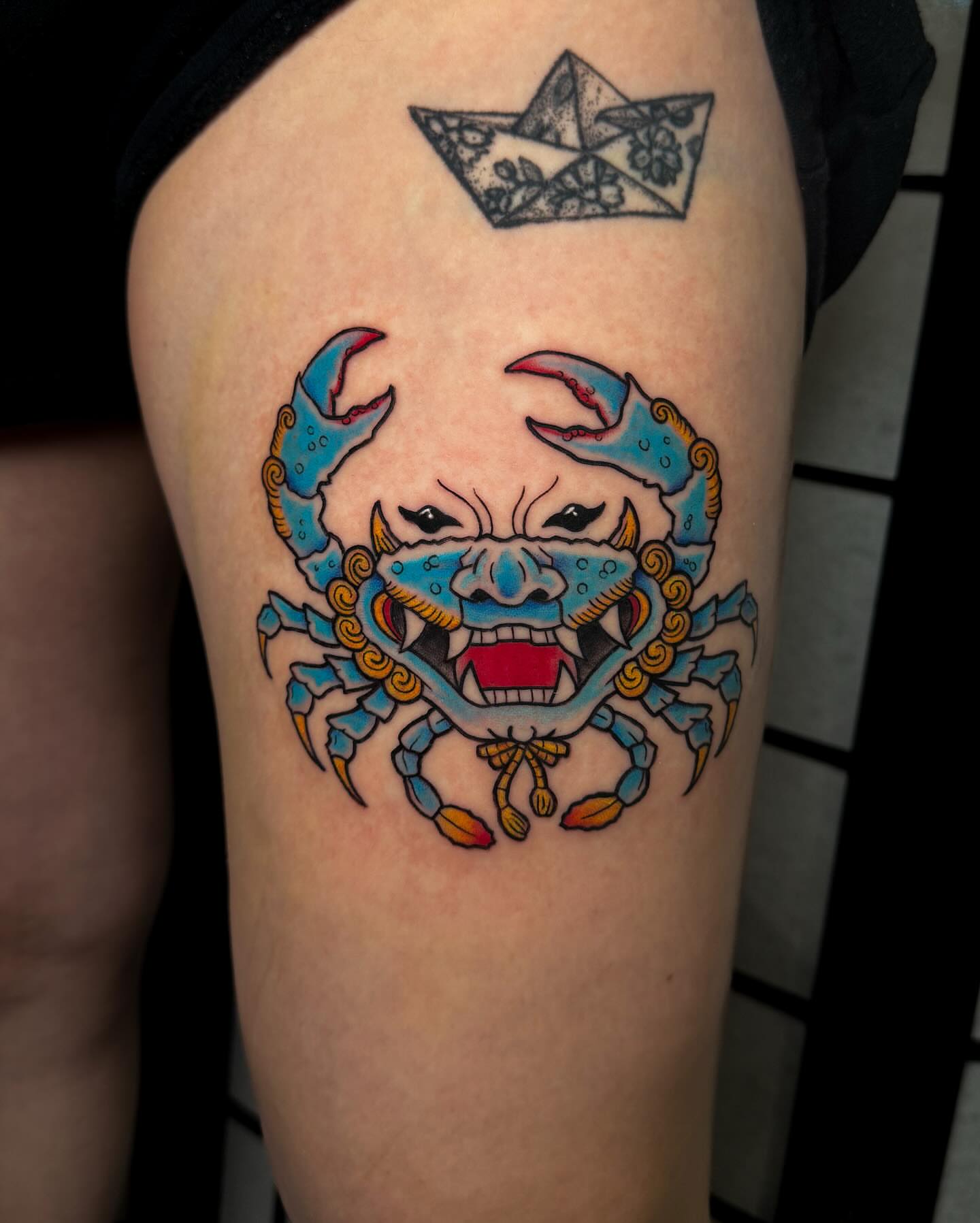 Angry crab American traditional tattoo on the thigh by Demi DiMartino