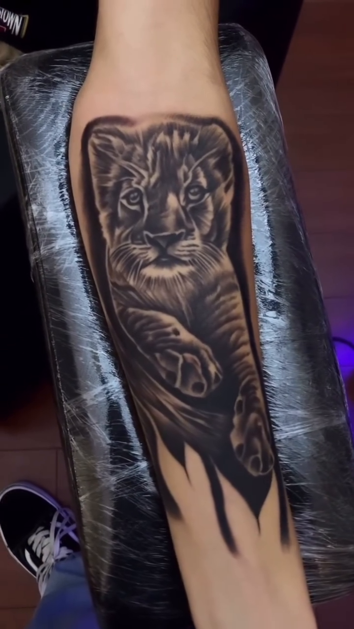 Lion cub realism tattoo by TattooBoyTattoos