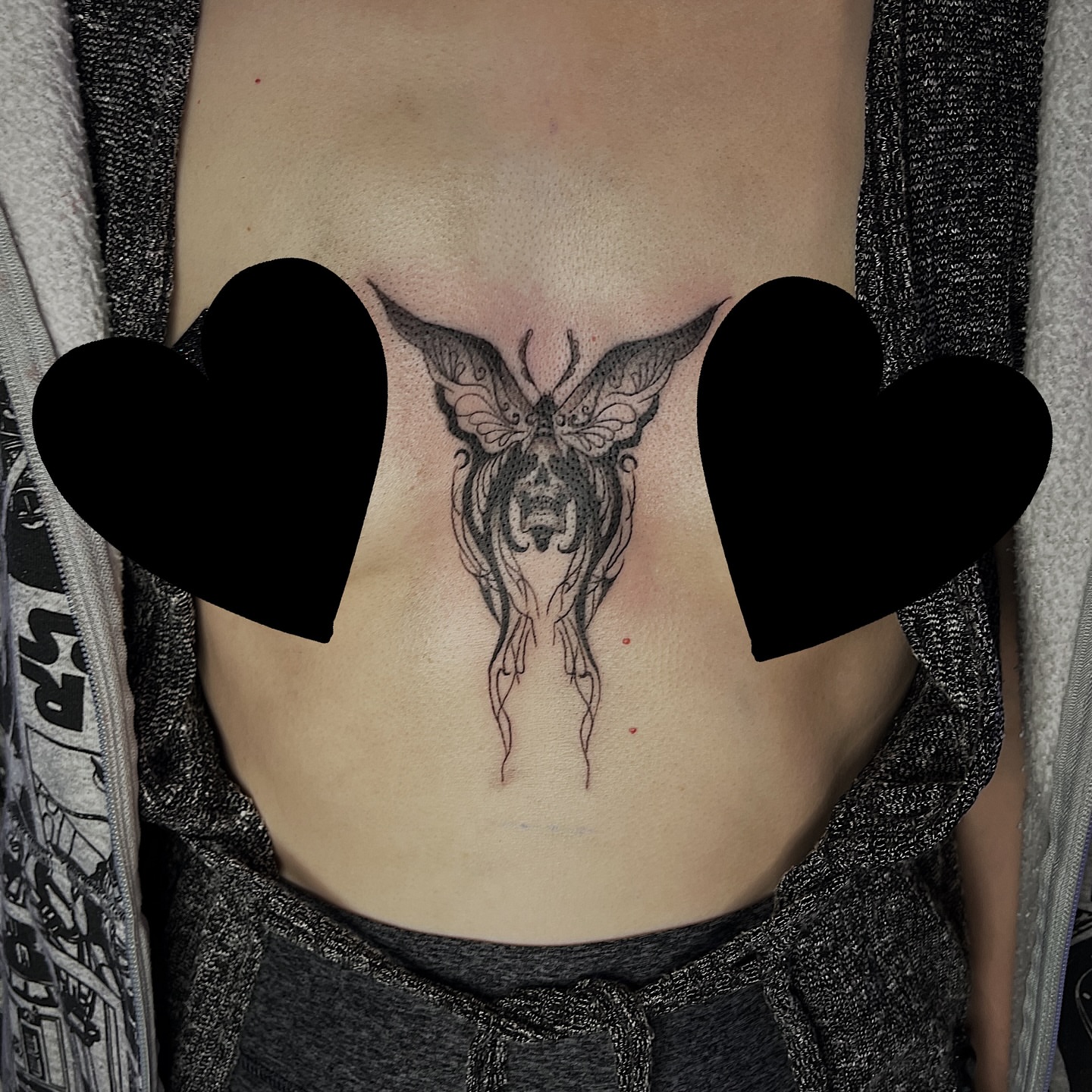 Butterfly black and grey tattoo on the torso by Nikki Ward
