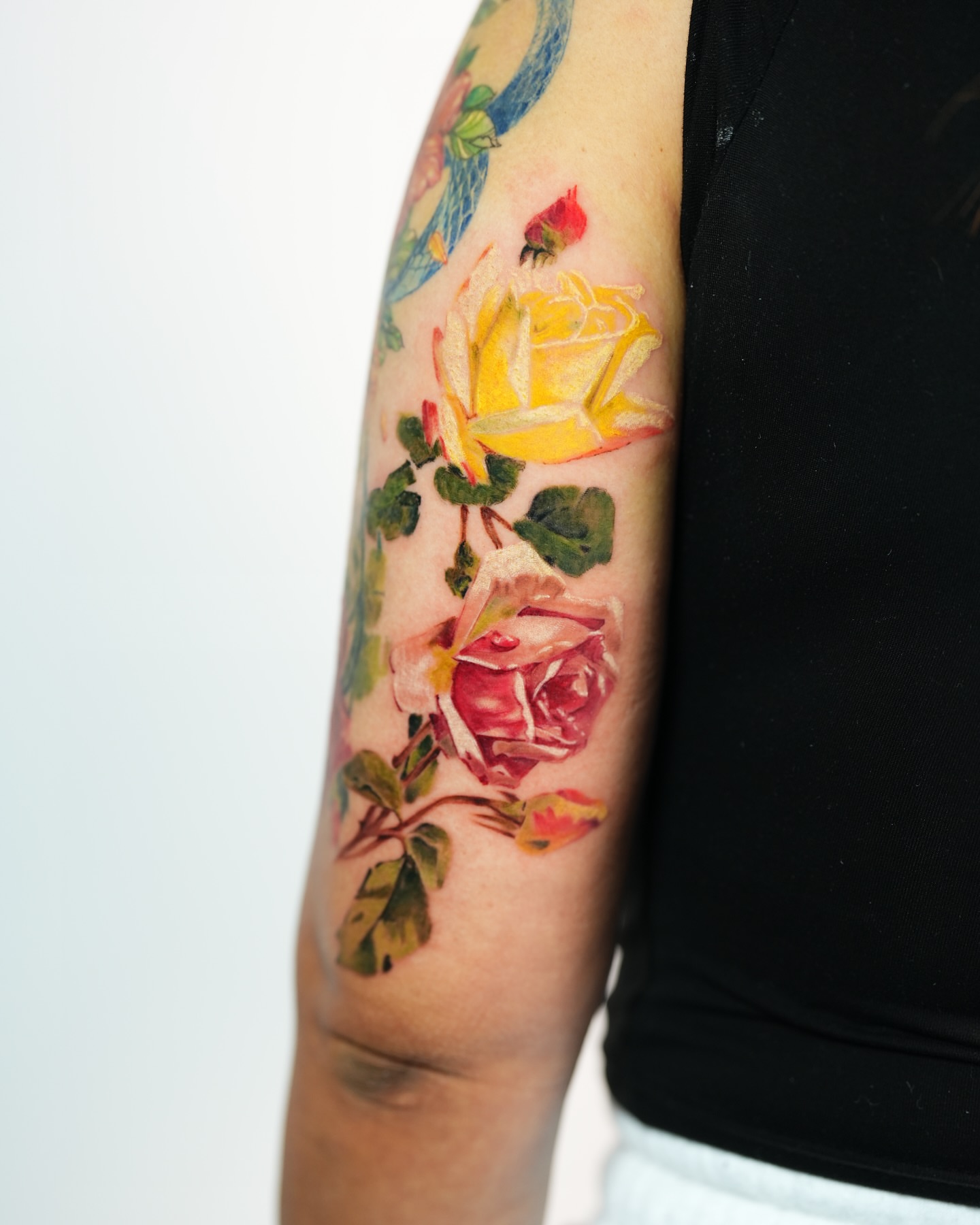 Roses realism tattoo on the forearm by Henry