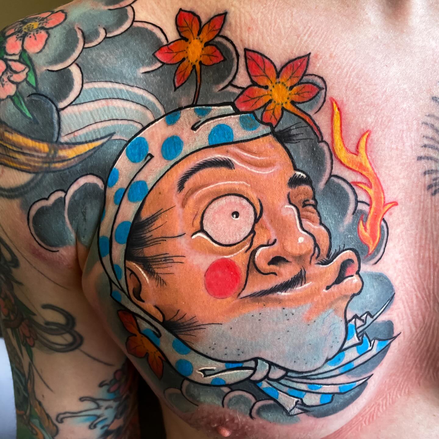 Clown face American traditional tattoo on the chest by Eric James, Phoenix, Arizona