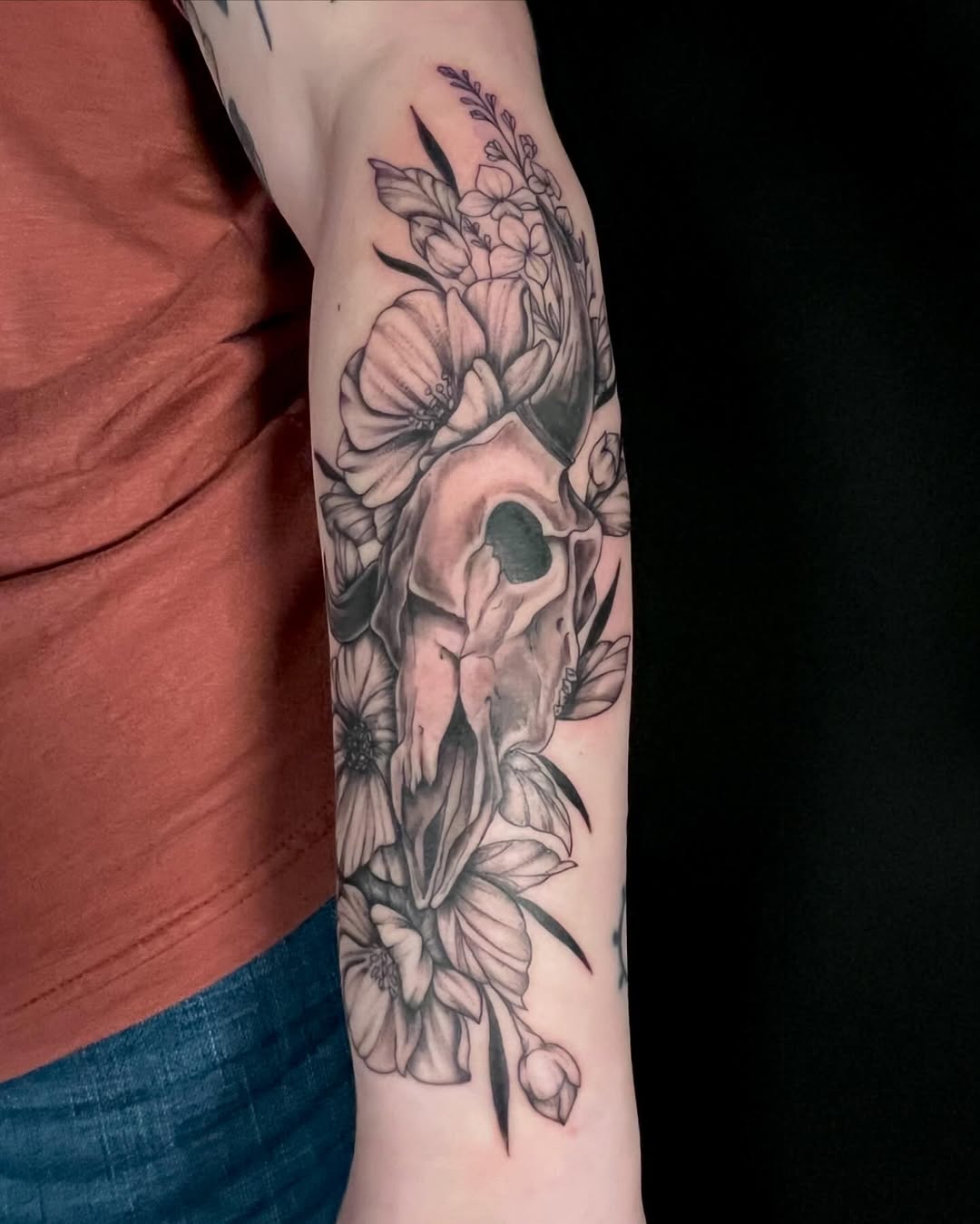 Skull and flowers dark art tattoo on the forearm by Alaska ⚜️