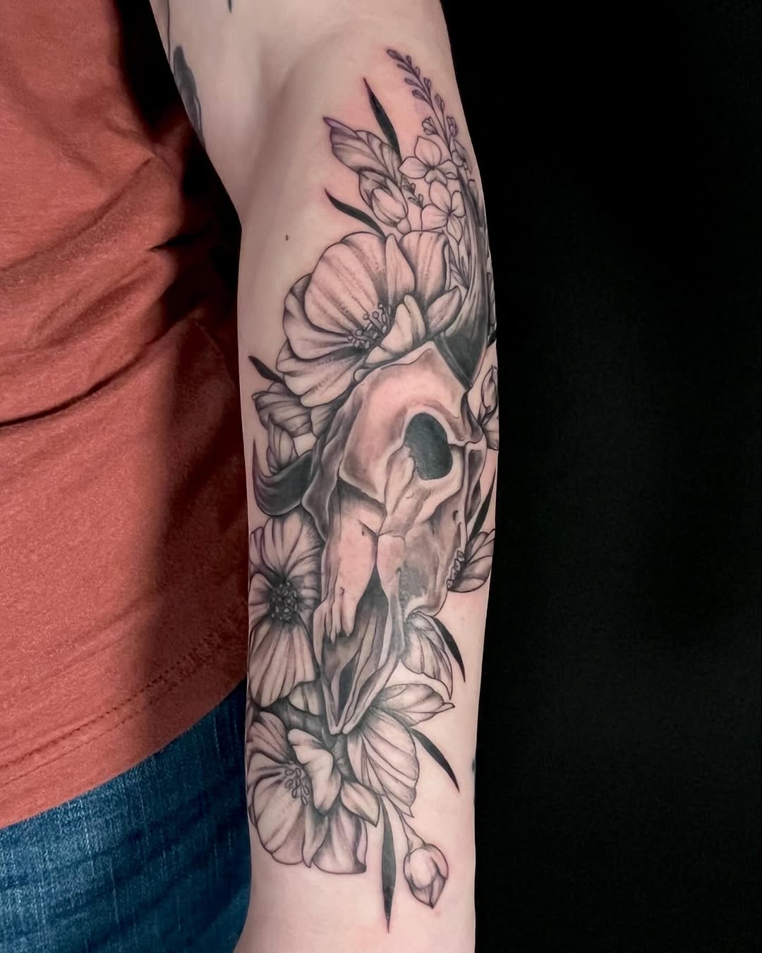 Skull and flowers realism tattoo on the forearm by Alaska ⚜️