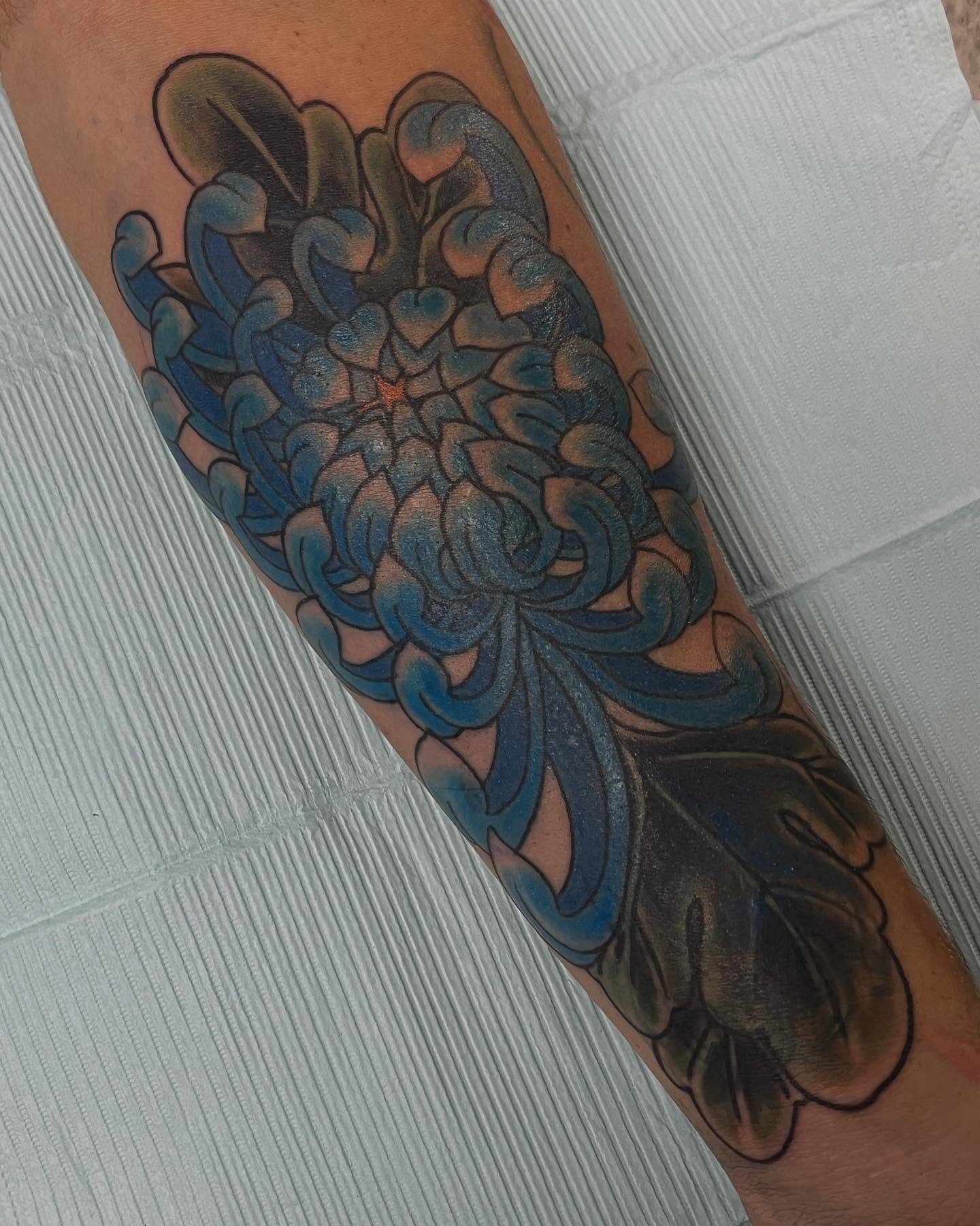 Chrysanthemum japanese irezumi tattoo on the forearm by Andrew Snowden