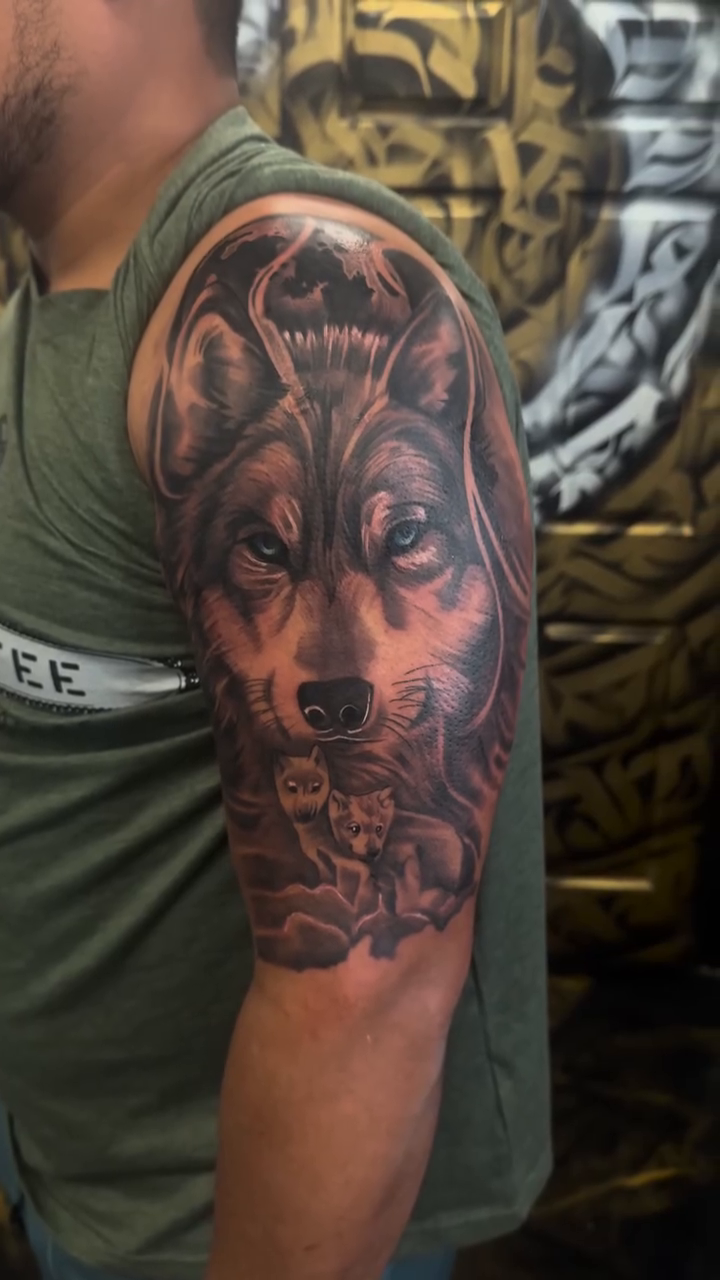 Wolf head with roses realism tattoo by Fernando Luna