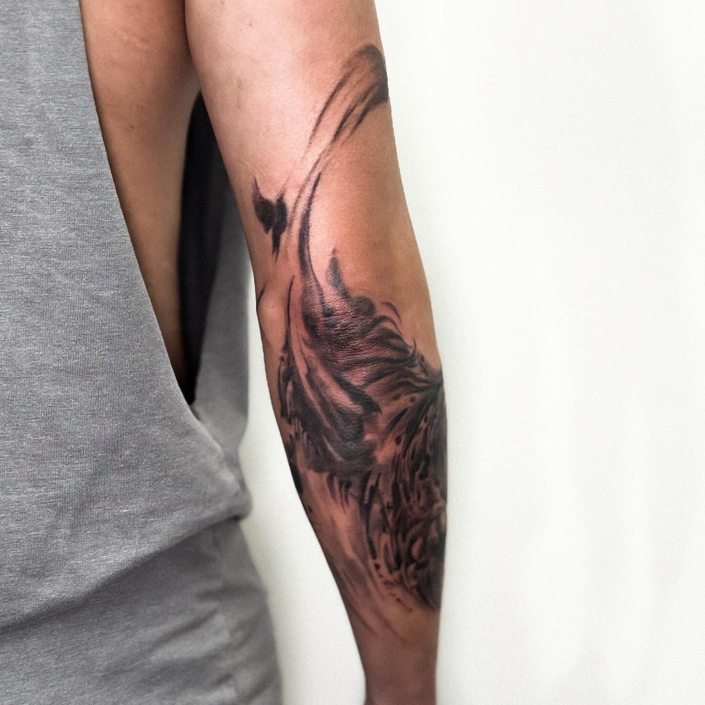 Flame black and grey tattoo on the forearm by Banky
