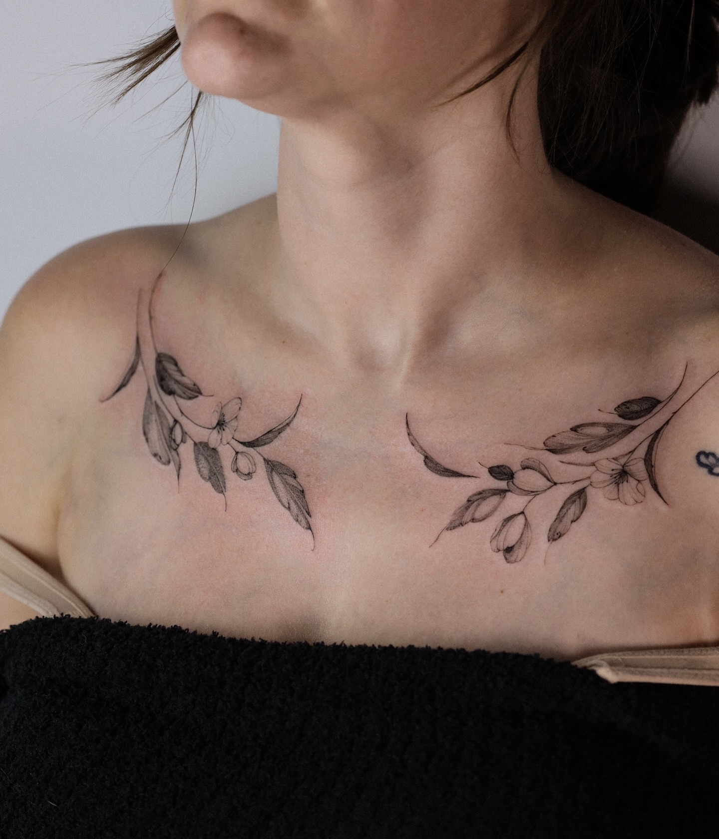 Flower branch black and grey tattoo on the chest by Maria