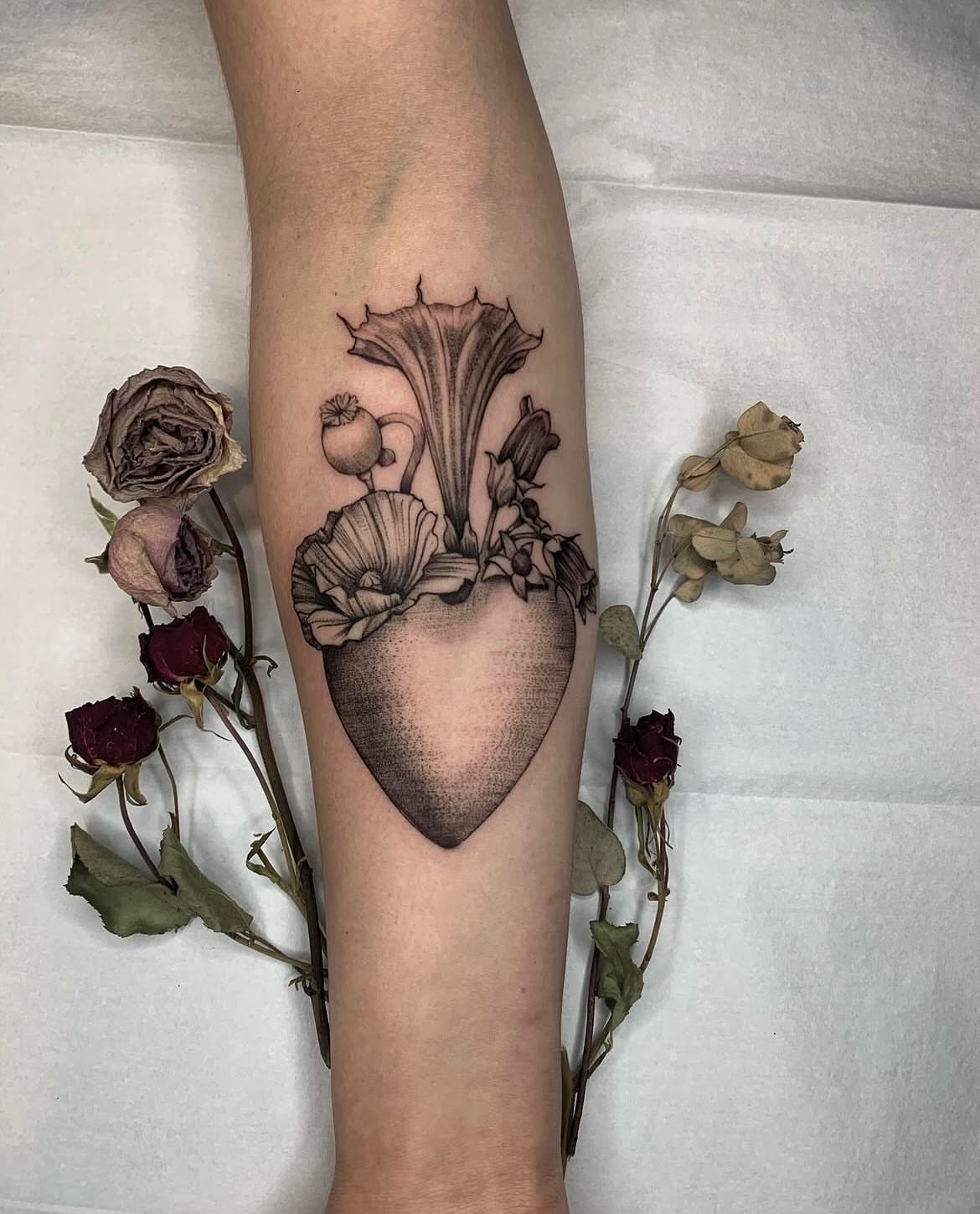 Heart with flowers black and grey tattoo on the forearm by Jamie Draven 🐺