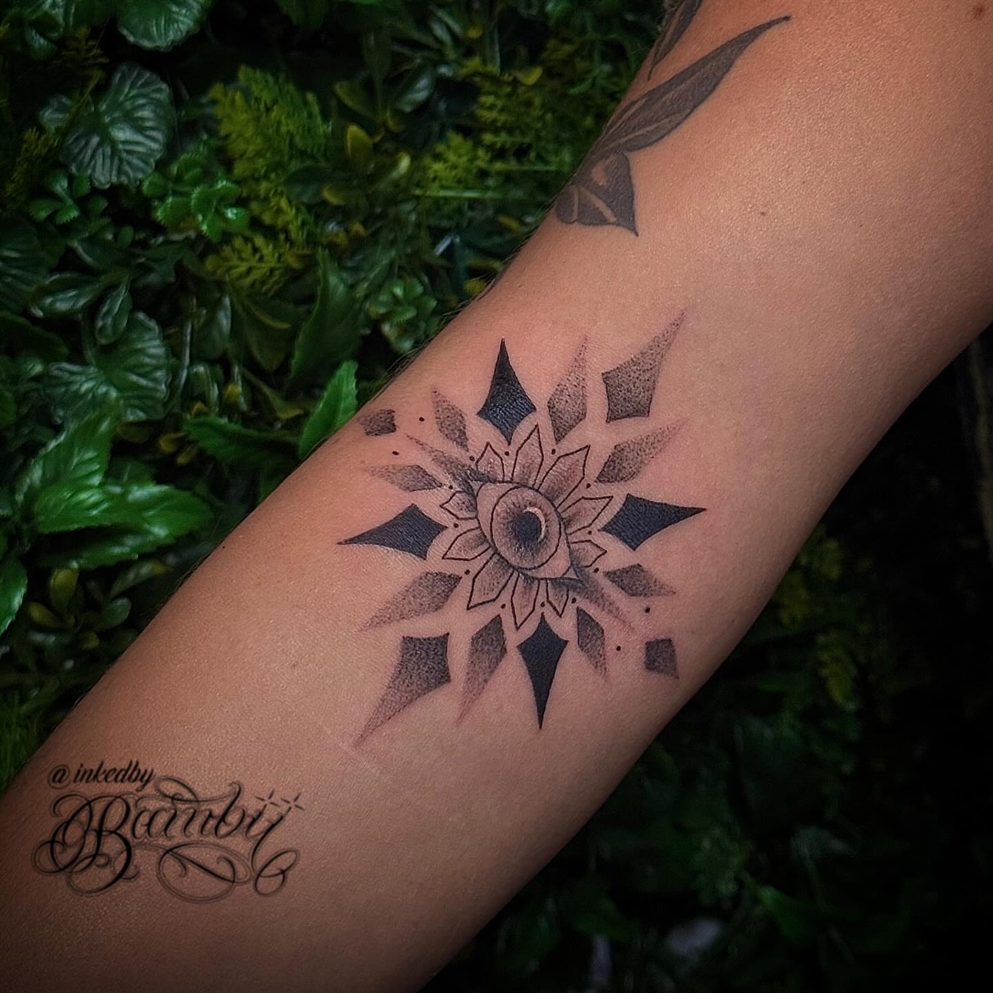 Sunburst dotwork tattoo on the forearm by Ember