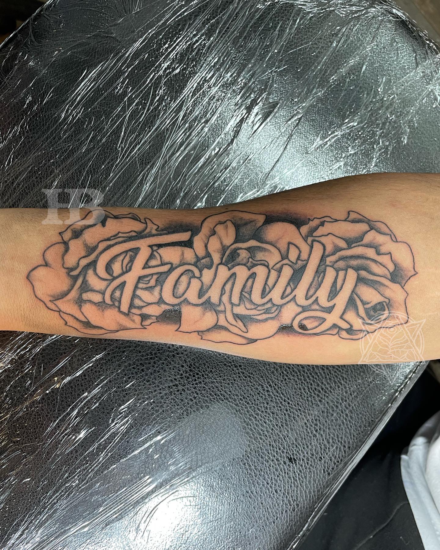 Family lettering script tattoo on the forearm by Hunter Beyer