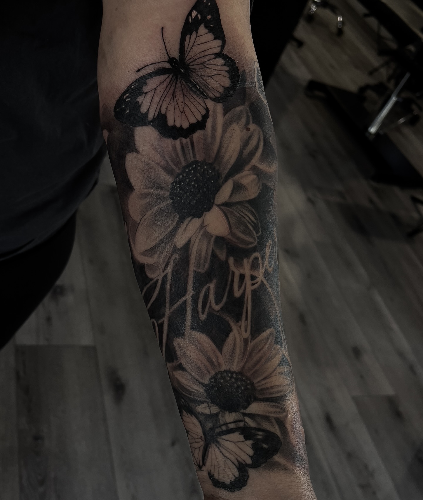Sunflower and butterfly realism tattoo on the forearm by Andy