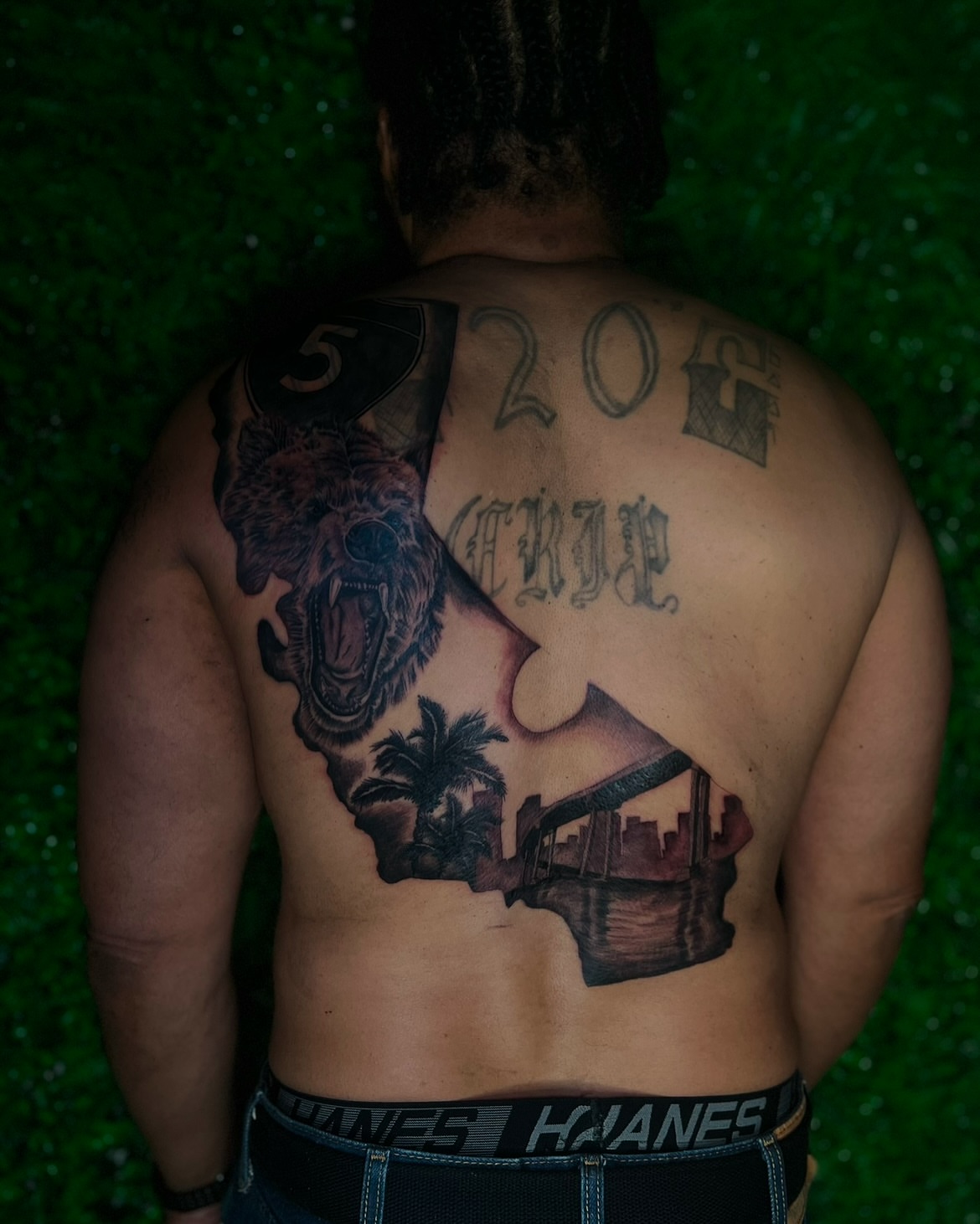 Bear and cityscape realism tattoo on the back by Los Angeles Tattoo Artist