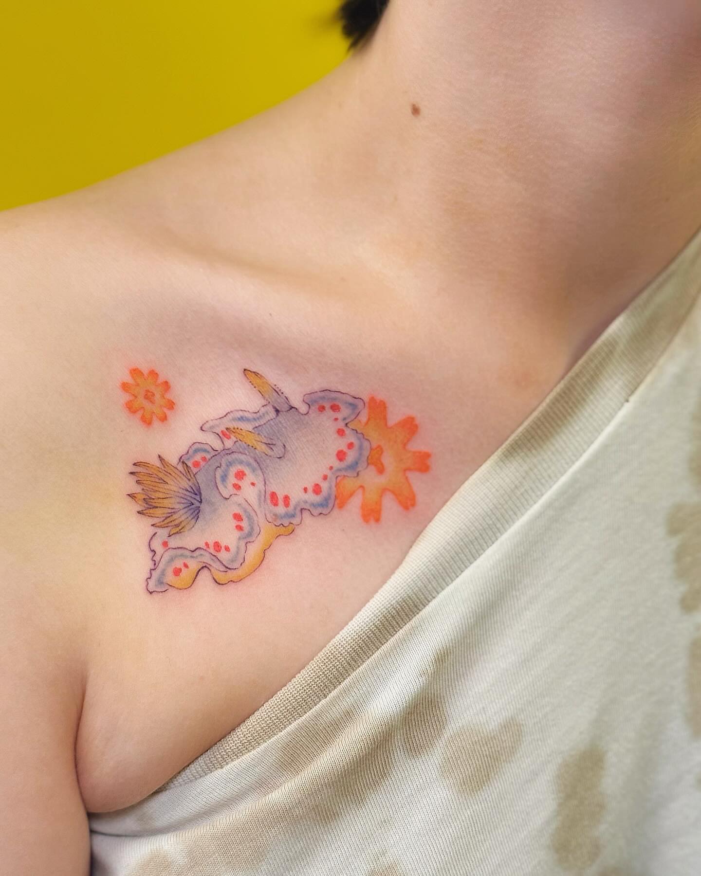 Fish and flowers American traditional tattoo on the chest by Echo