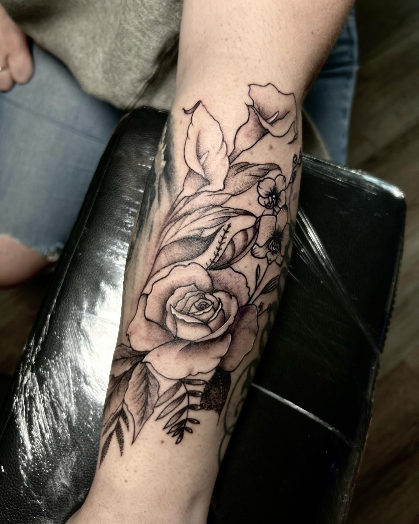 Rose and calla lilies black and grey tattoo on the forearm by Jelly