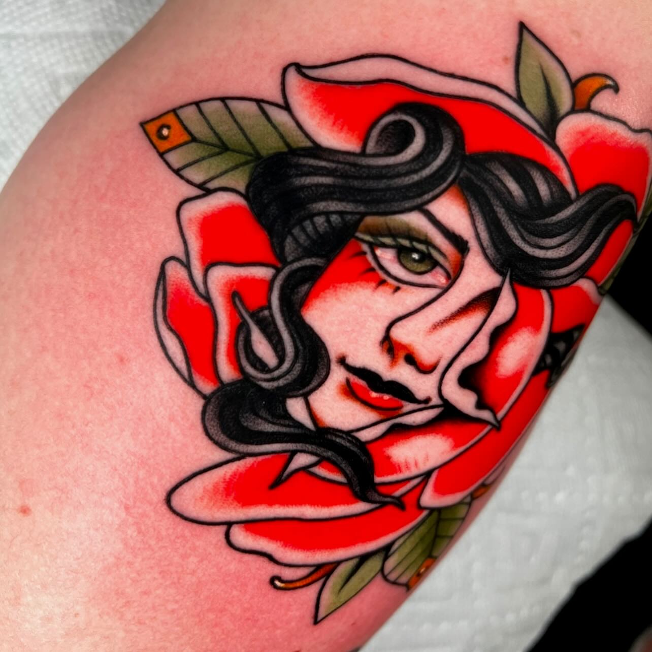 Woman in rose American traditional tattoo on the shoulder by Hailey Johnson