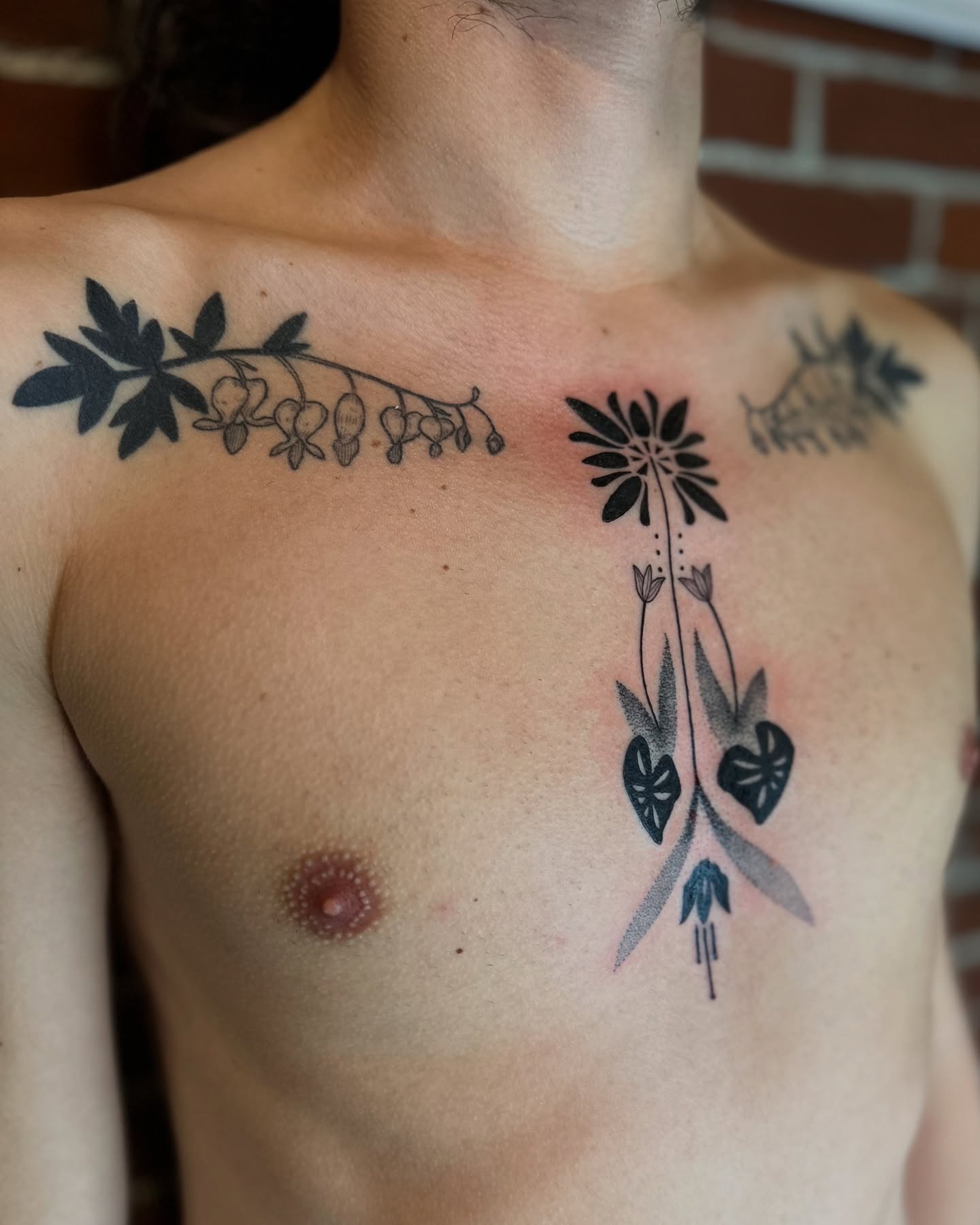 Floral arrangement black and grey tattoo on the chest by Alexandra Gray