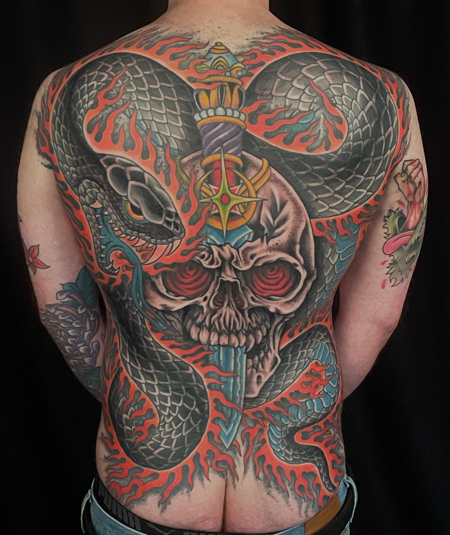 Skull with snakes American traditional tattoo on the back by Haley McMahon