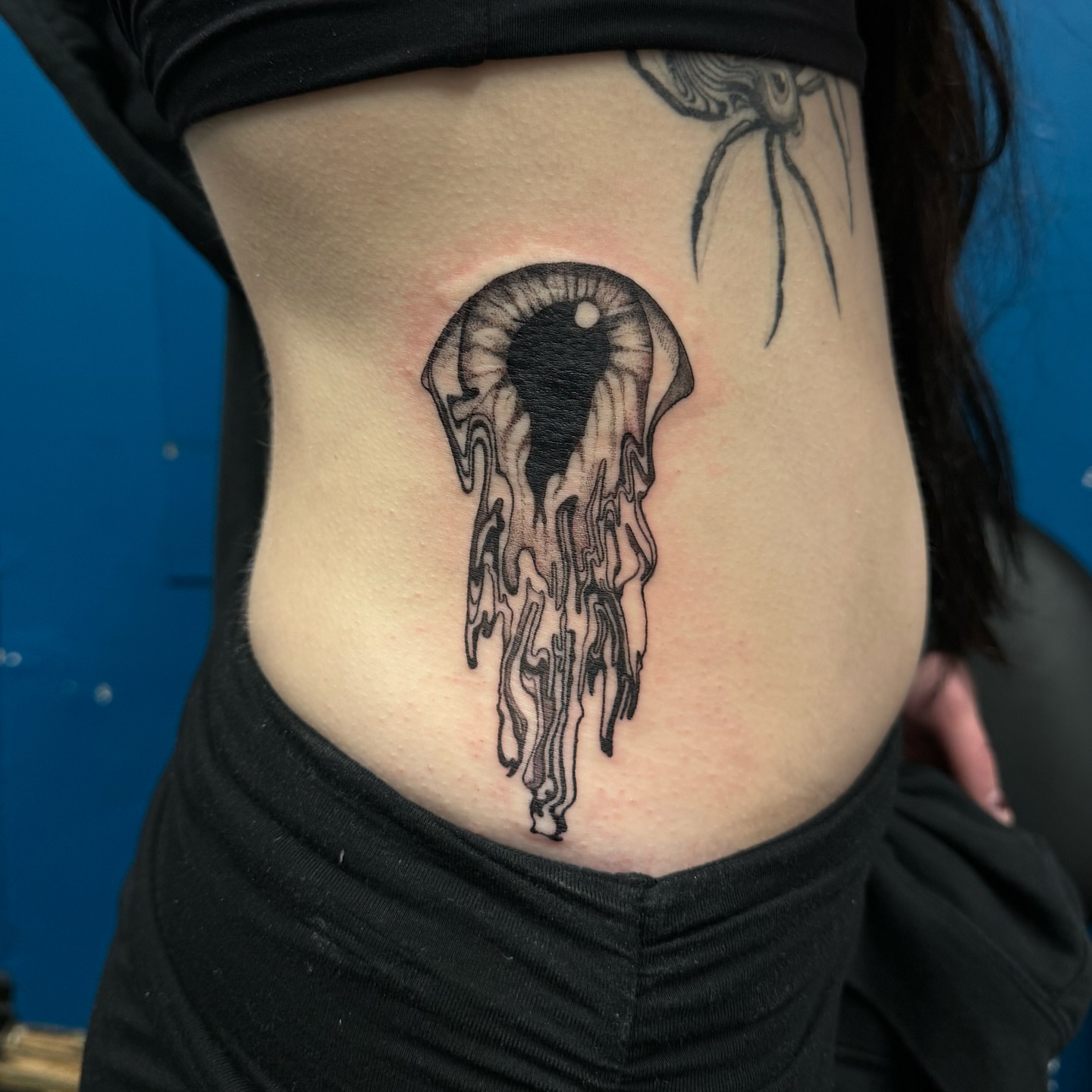 Melting eye black and grey tattoo on the ribs by Shannon, Cincinnati, Ohio