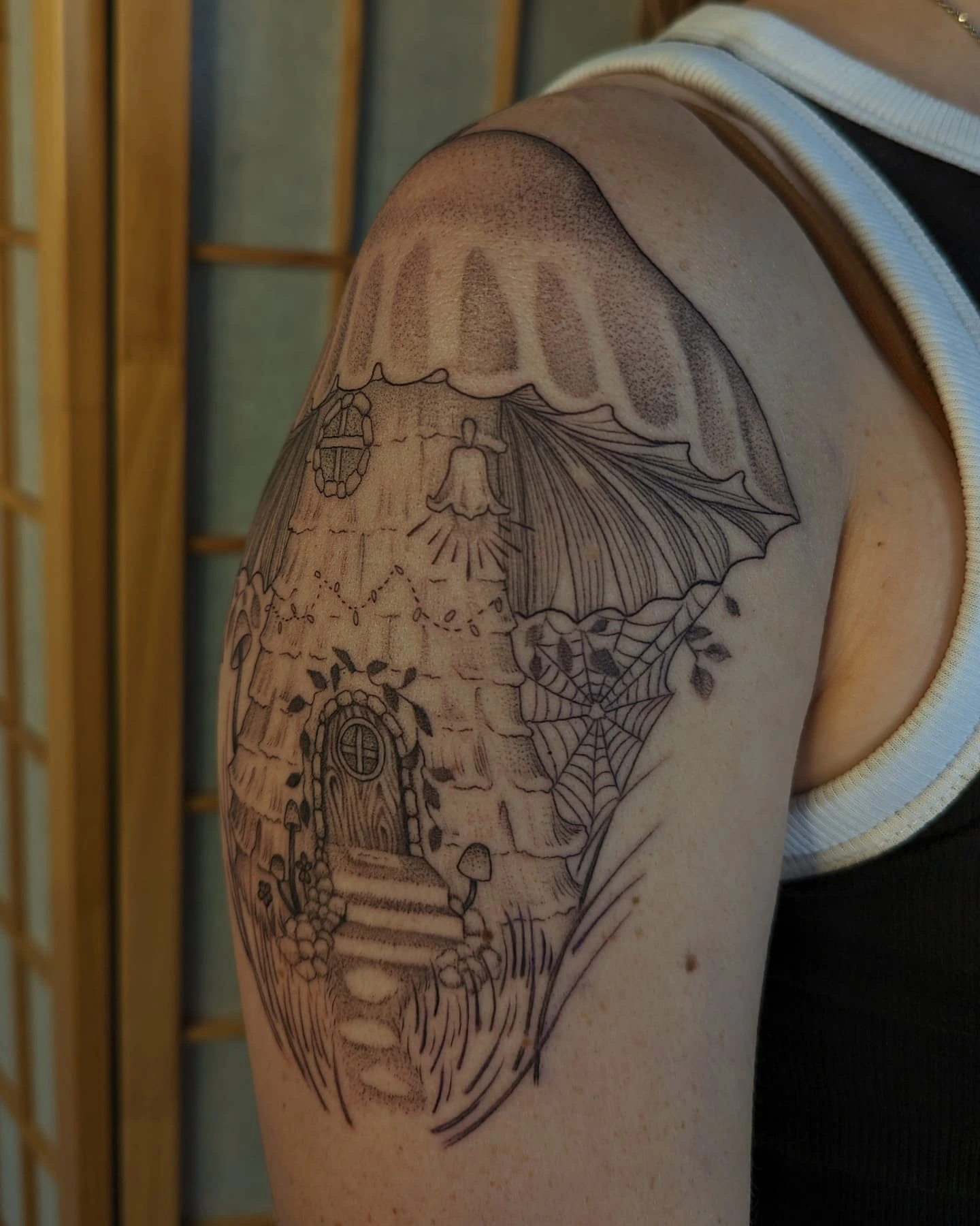 Mushroom house dotwork tattoo on the shoulder by Jeanine, Providence, Rhode Island