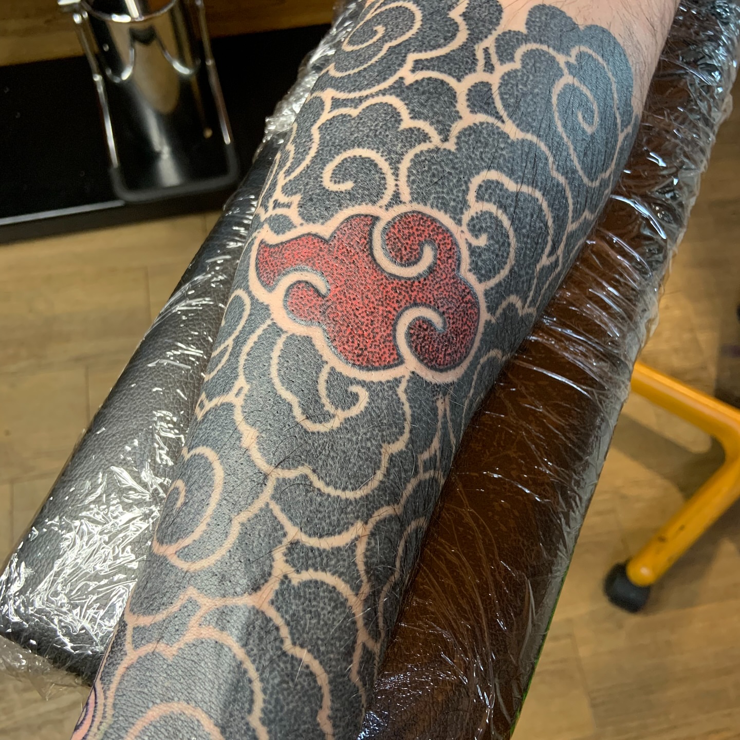 Clouds and heart dotwork tattoo on the forearm by Bombay Pain Co.