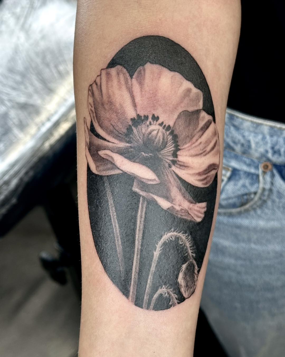 Poppy flower realism tattoo on the forearm by Harper Clark