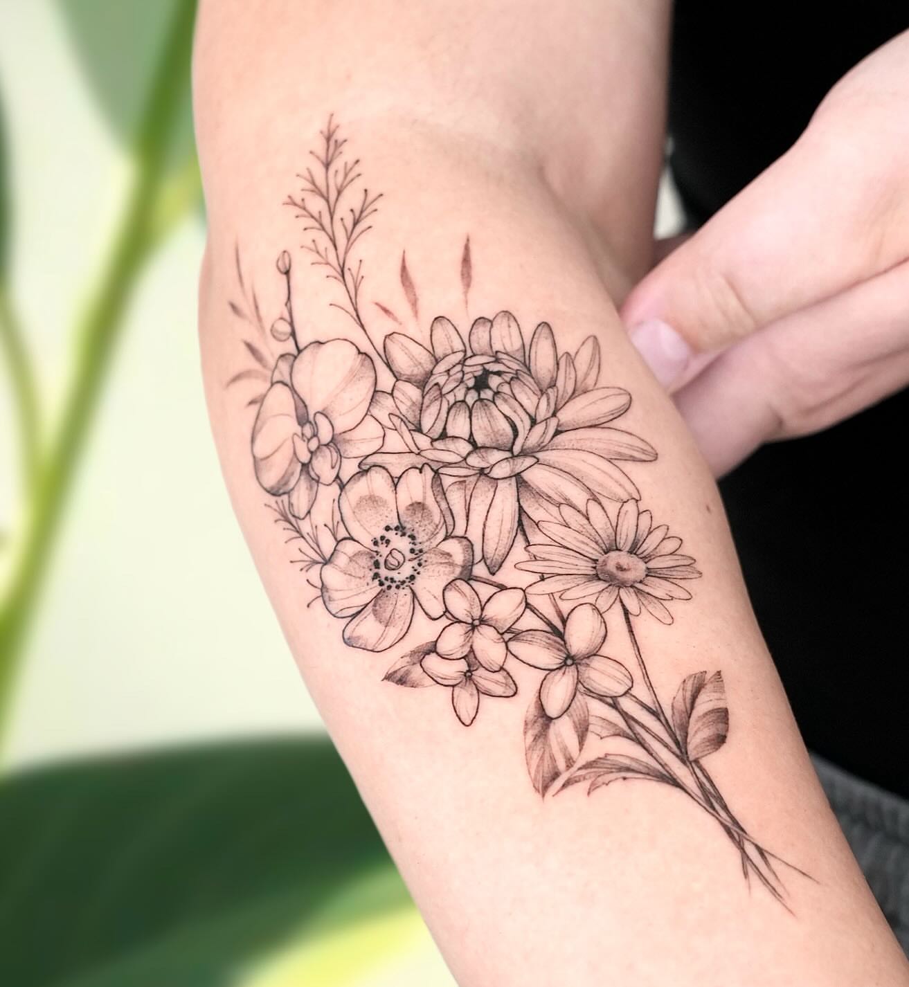 Floral bouquet black and grey tattoo on the forearm by Marianna D D King