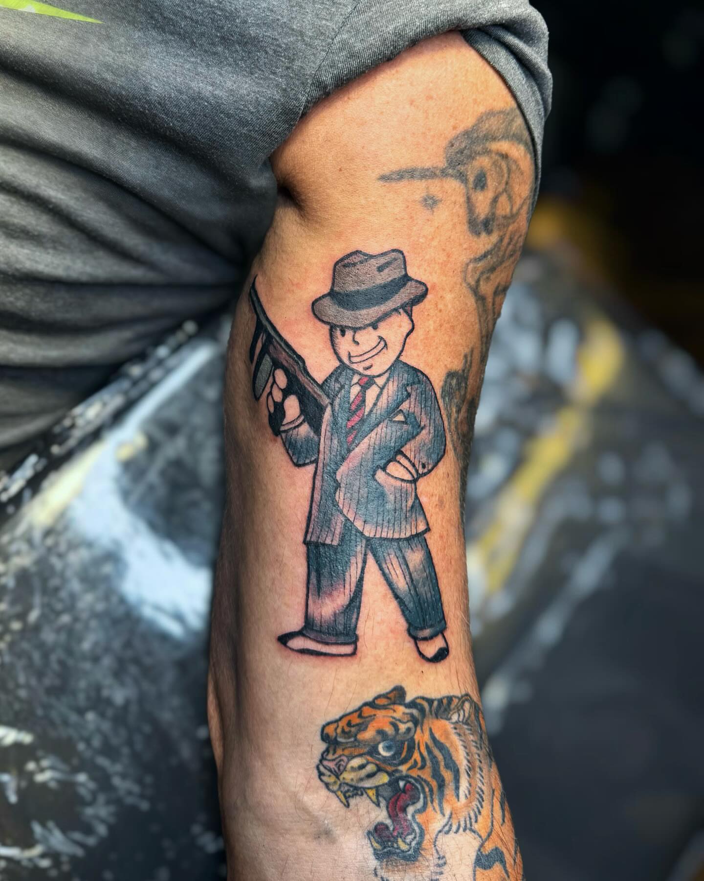 Gangster with gun American traditional tattoo on the forearm by Jewels, St. George, Utah