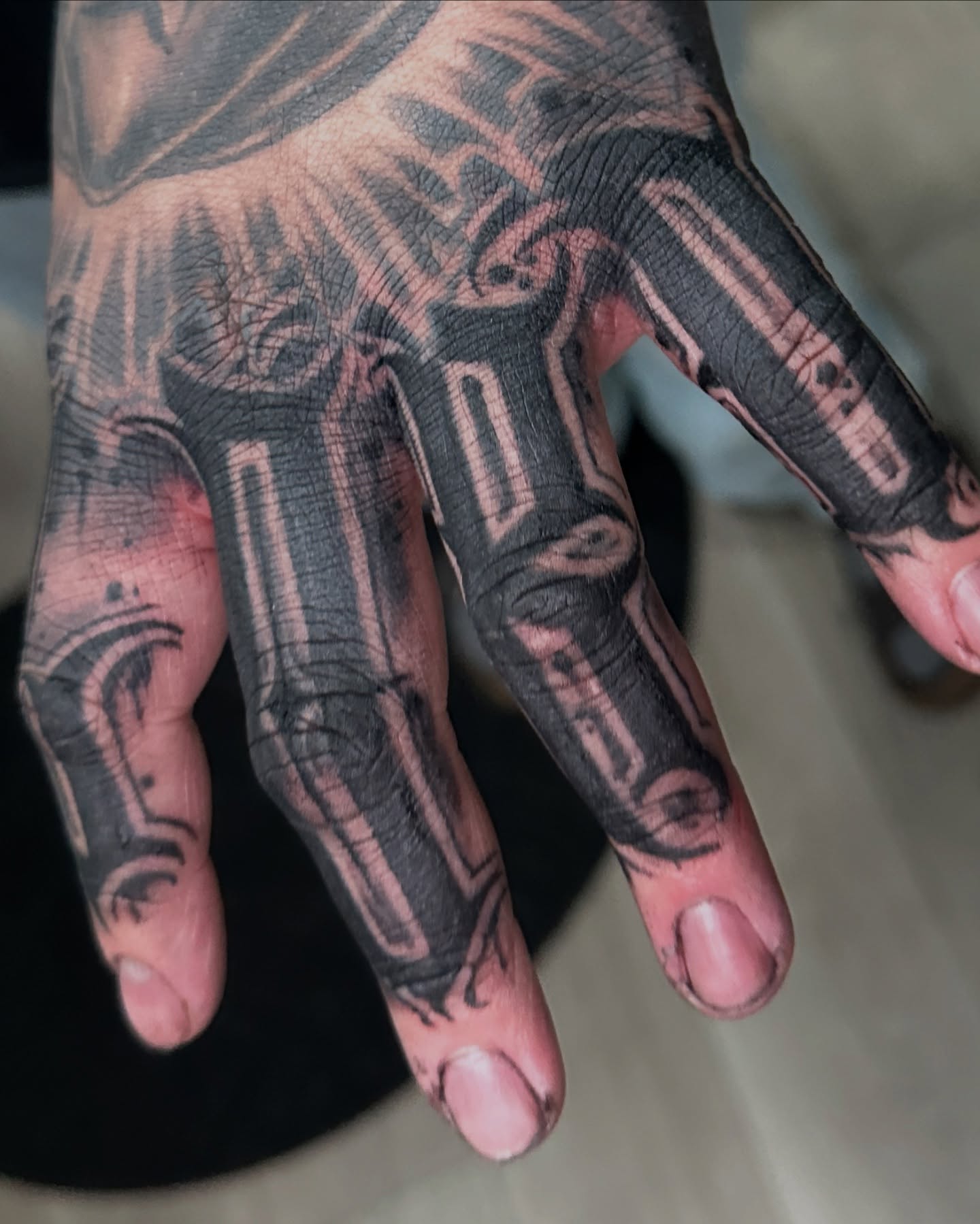 Mechanical hand black and grey tattoo on the hand by WestHustleArt