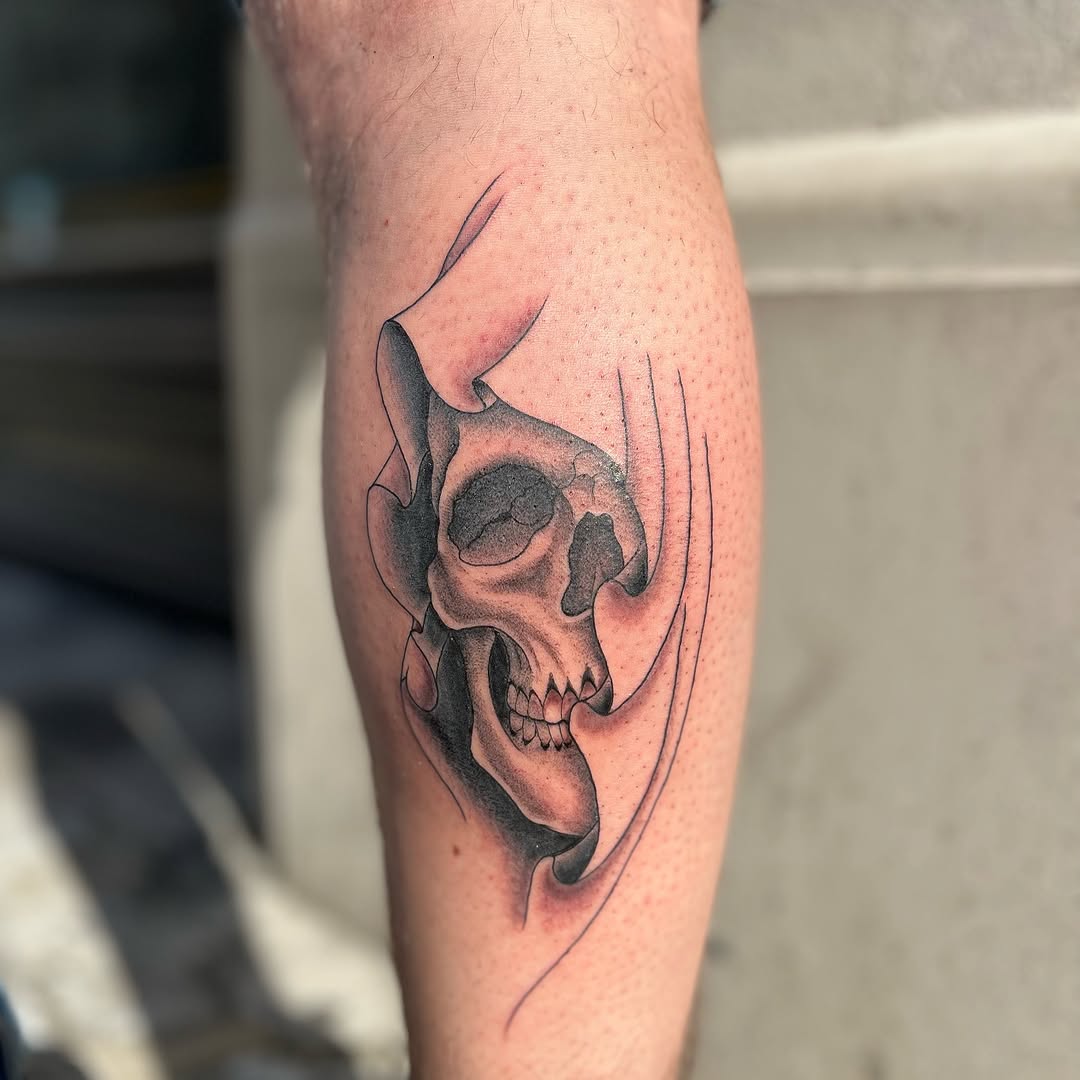 Skull emerging from fabric realism tattoo on the forearm by Tattoo, New York, New York