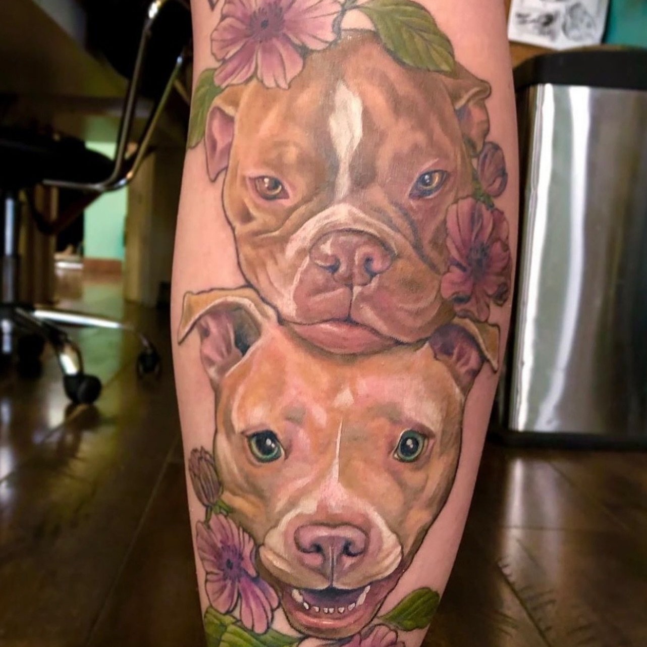 Pit bulls and flowers realism tattoo on the forearm by Chelsea Youngblood, Seattle, Washington