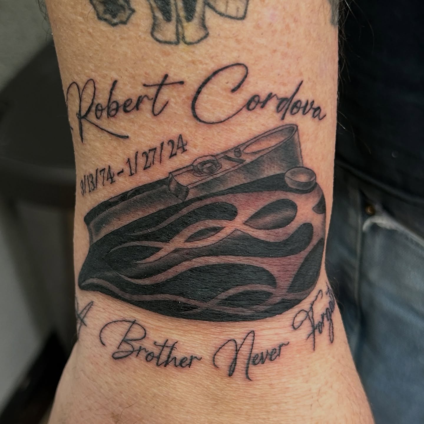Camera and flame realism tattoo on the forearm by Sean OHara
