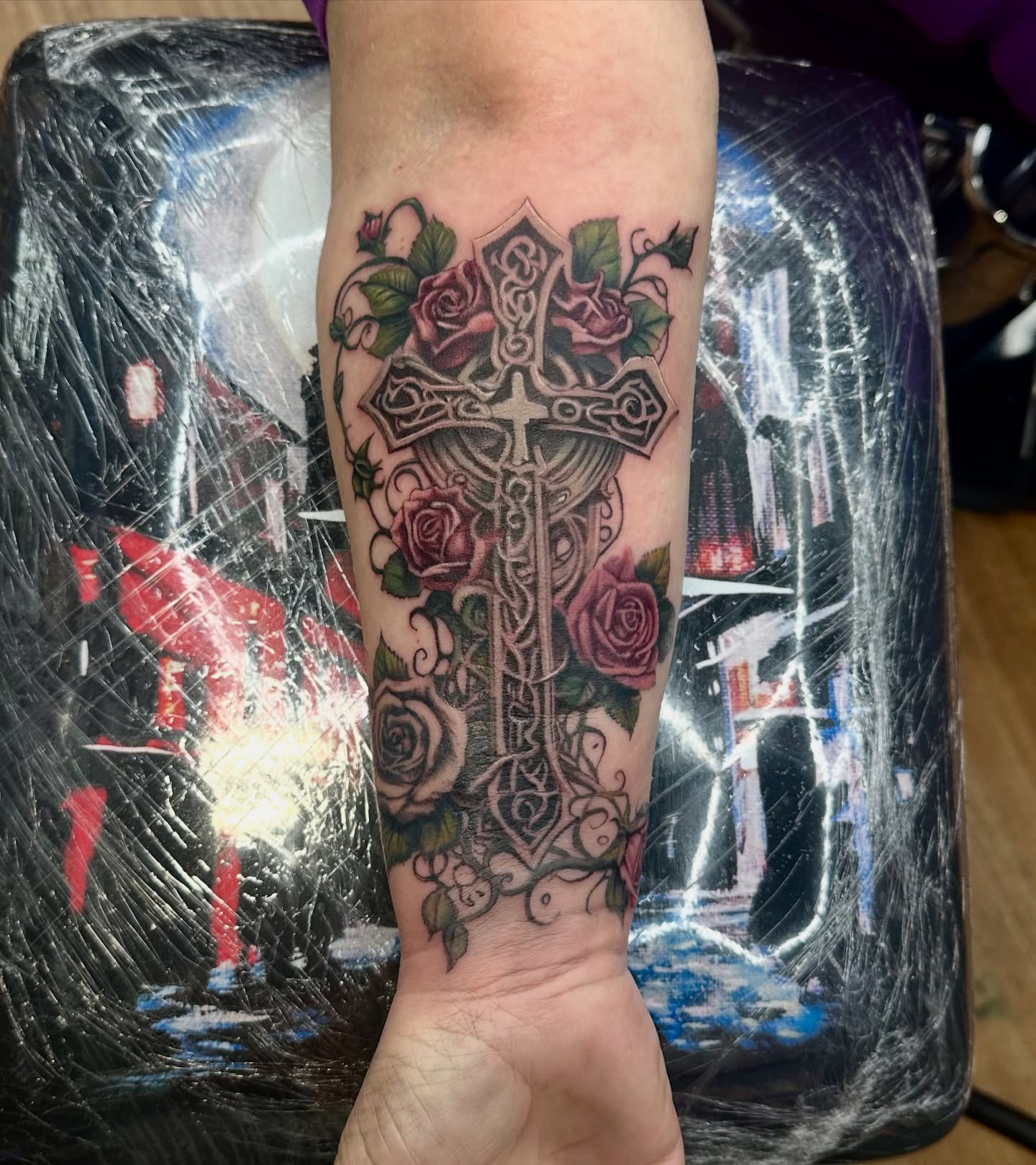 Cross with roses neo-traditional tattoo on the forearm by Tyler Reep
