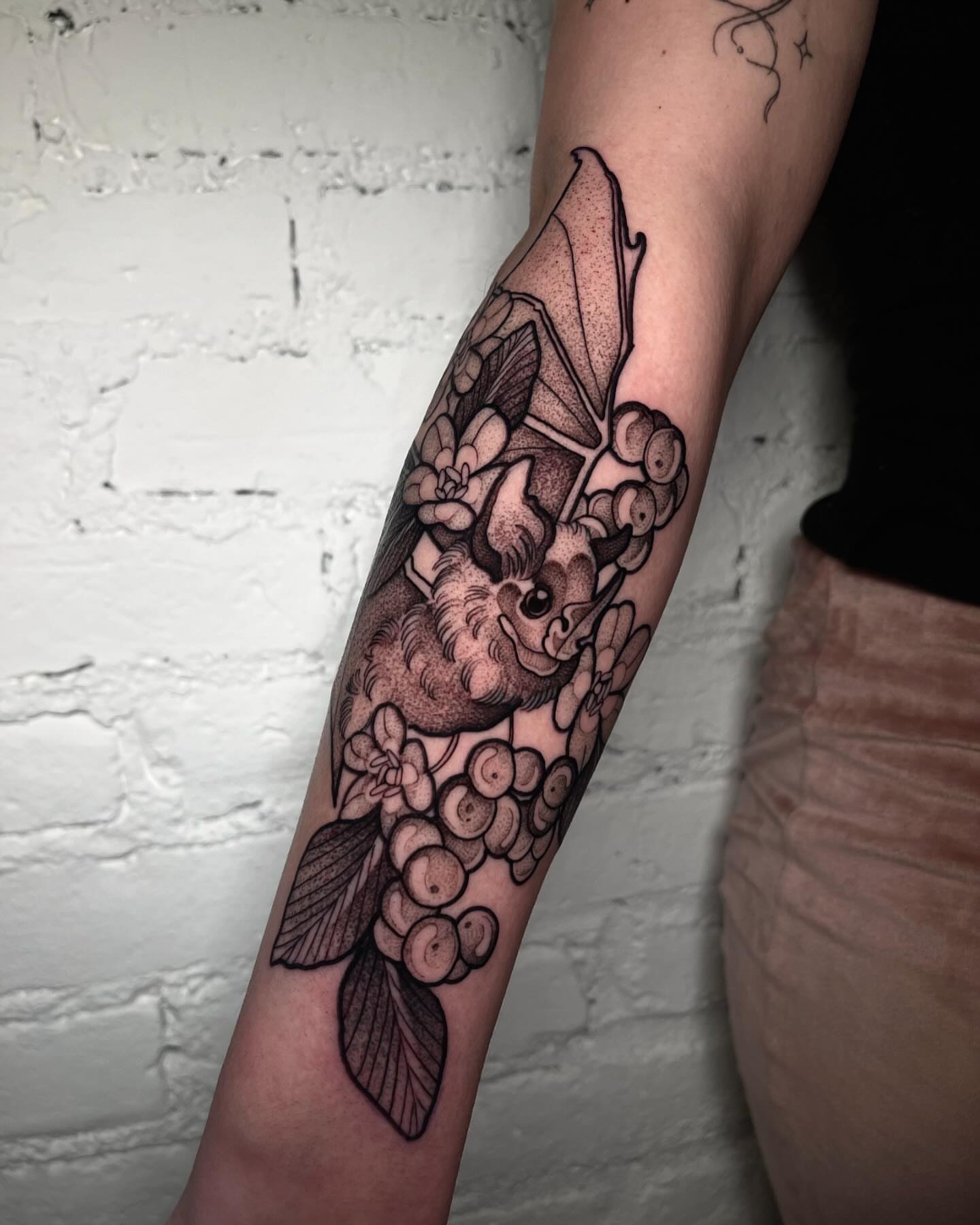 Bat and berries dotwork tattoo on the forearm by H A N N A H, Colorado Springs, Colorado