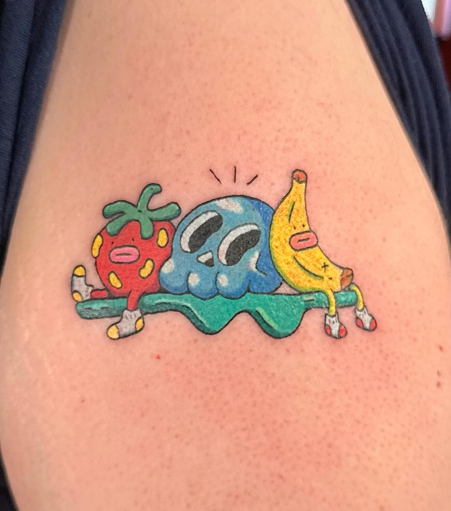 Fruit characters illustrative tattoo on the thigh by Kellie Burch